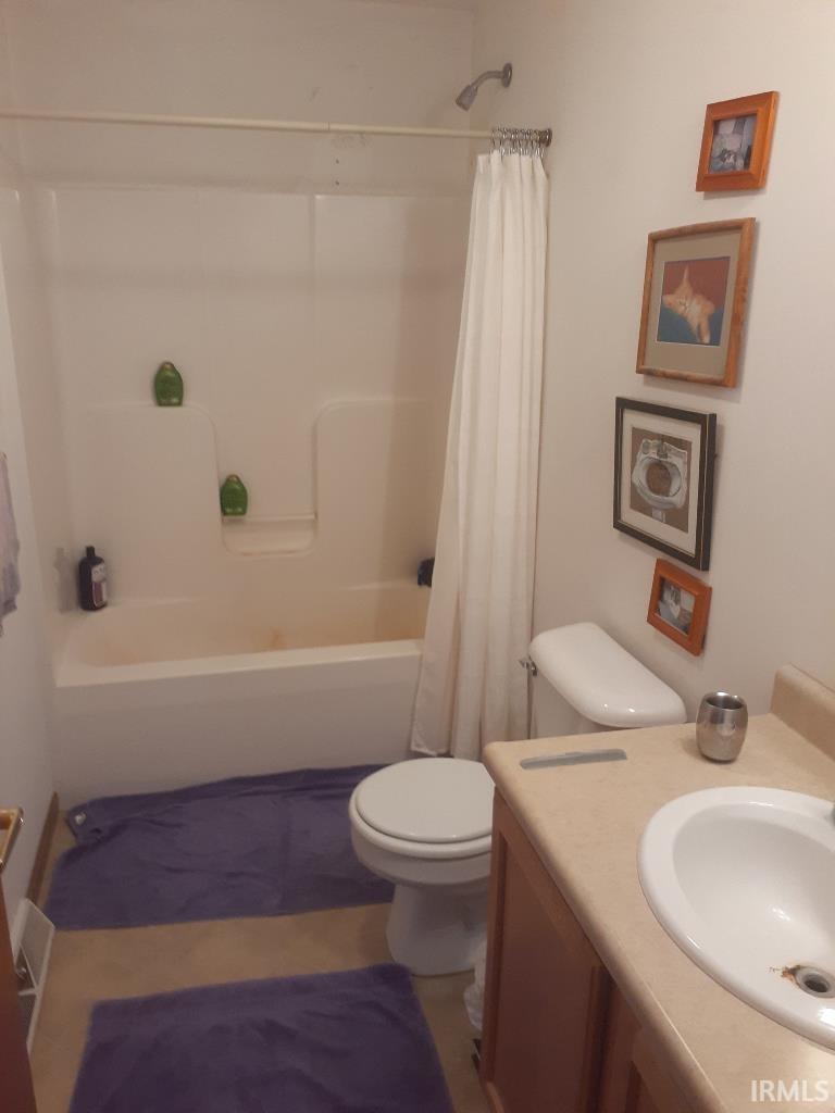 Full bath featuring vanity and shower / bath combo with shower curtain