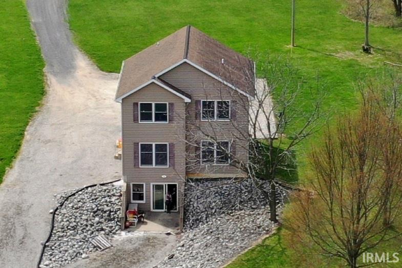 Rear view of house featuring a lawn