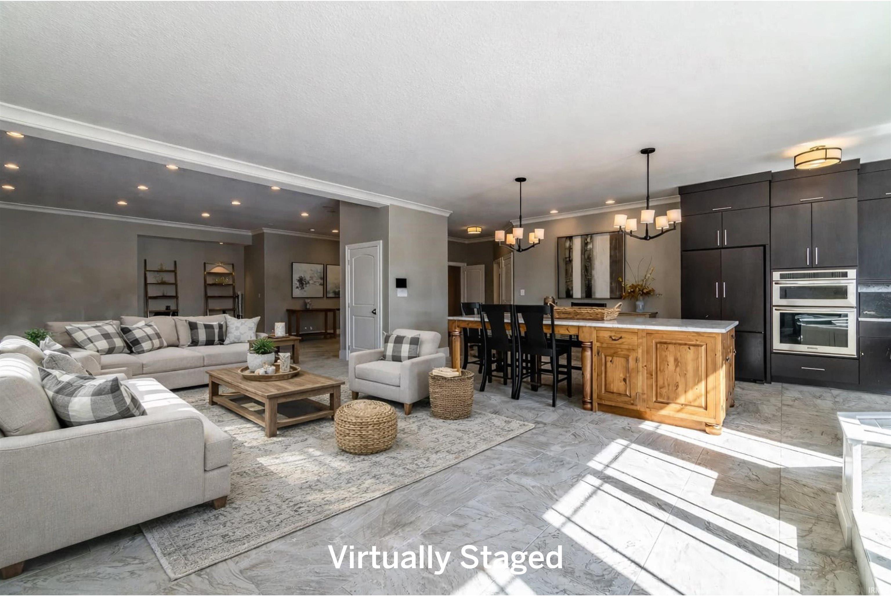 Living room featuring a chandelier, light marble finish flooring, and ornamental molding
