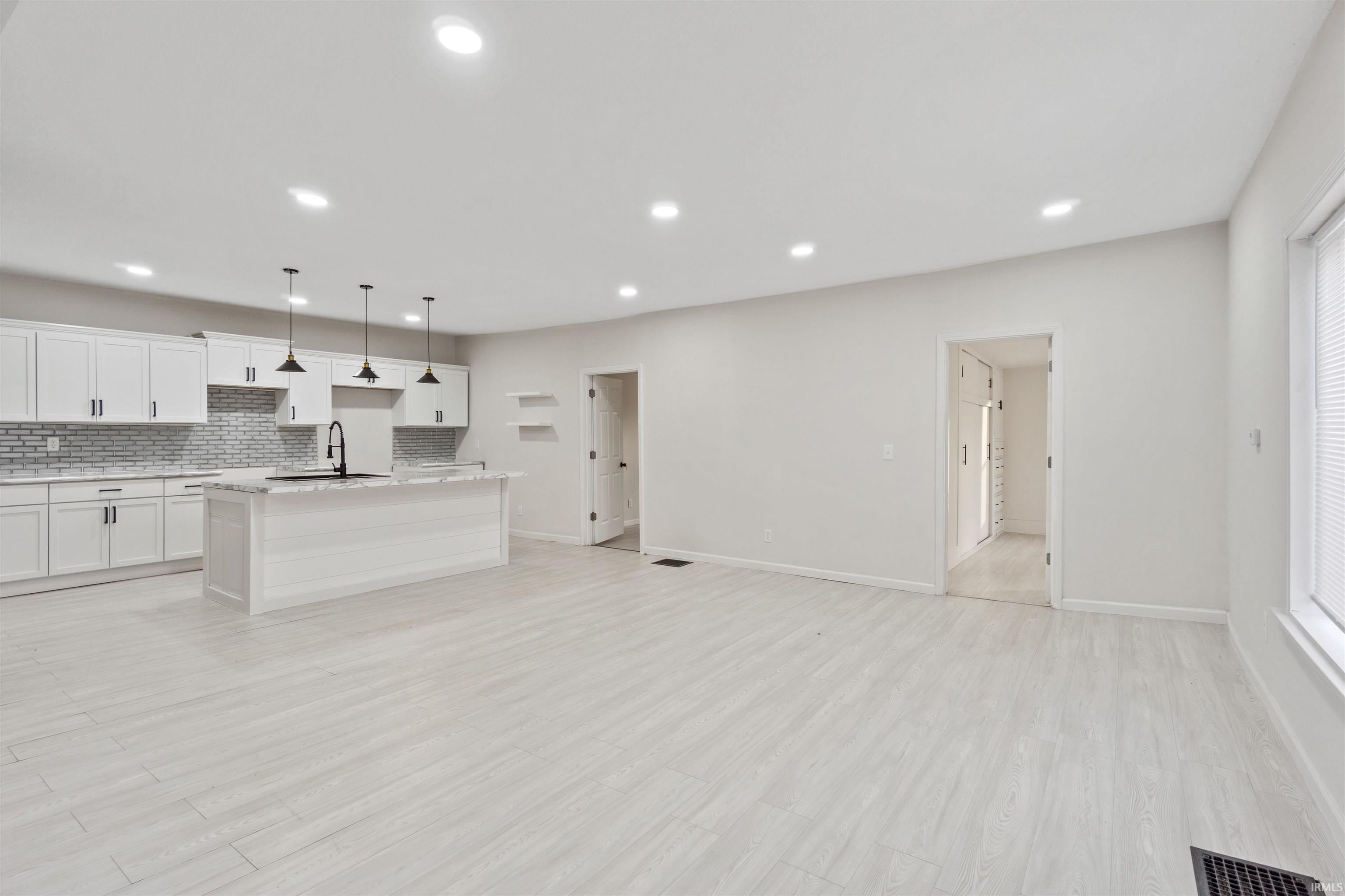 Unfurnished living room with light wood-style floors and recessed lighting