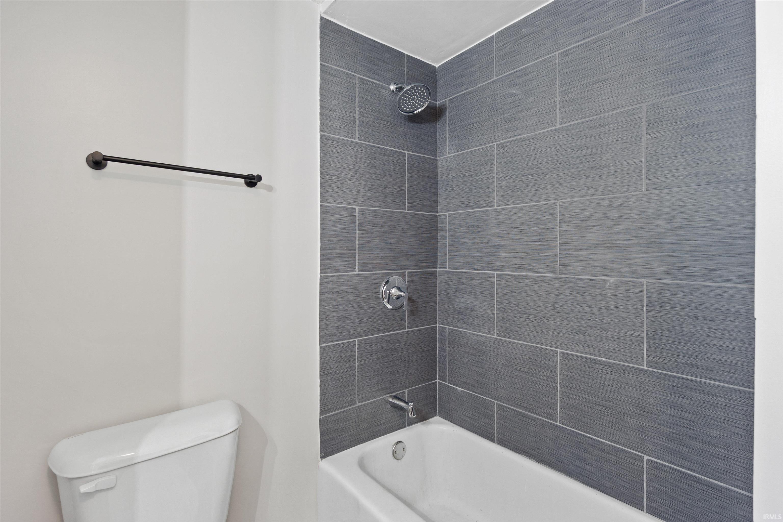 Full bath with shower / bath combination and toilet