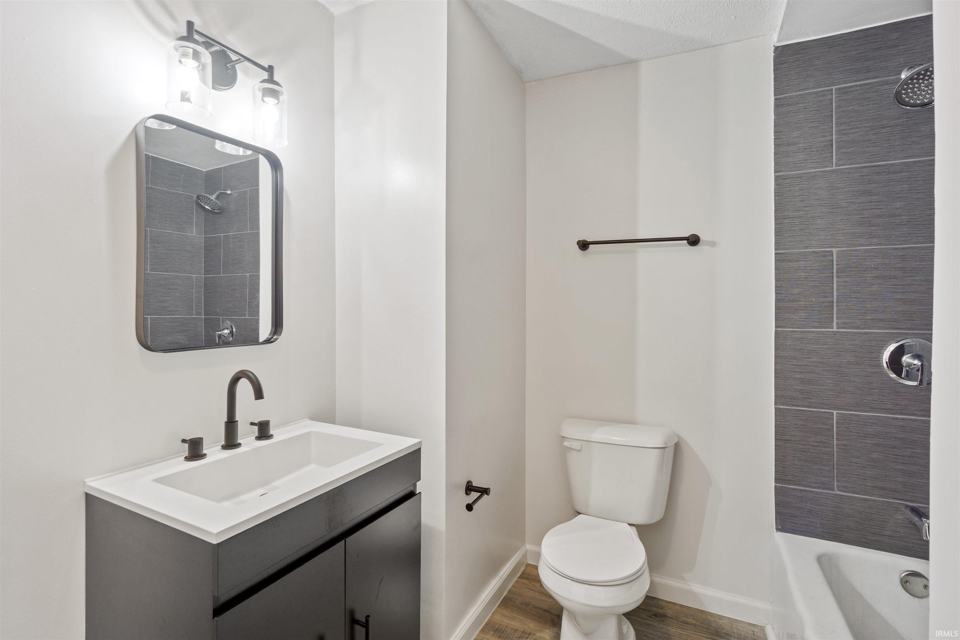 Full bath featuring vanity and bathtub / shower combination