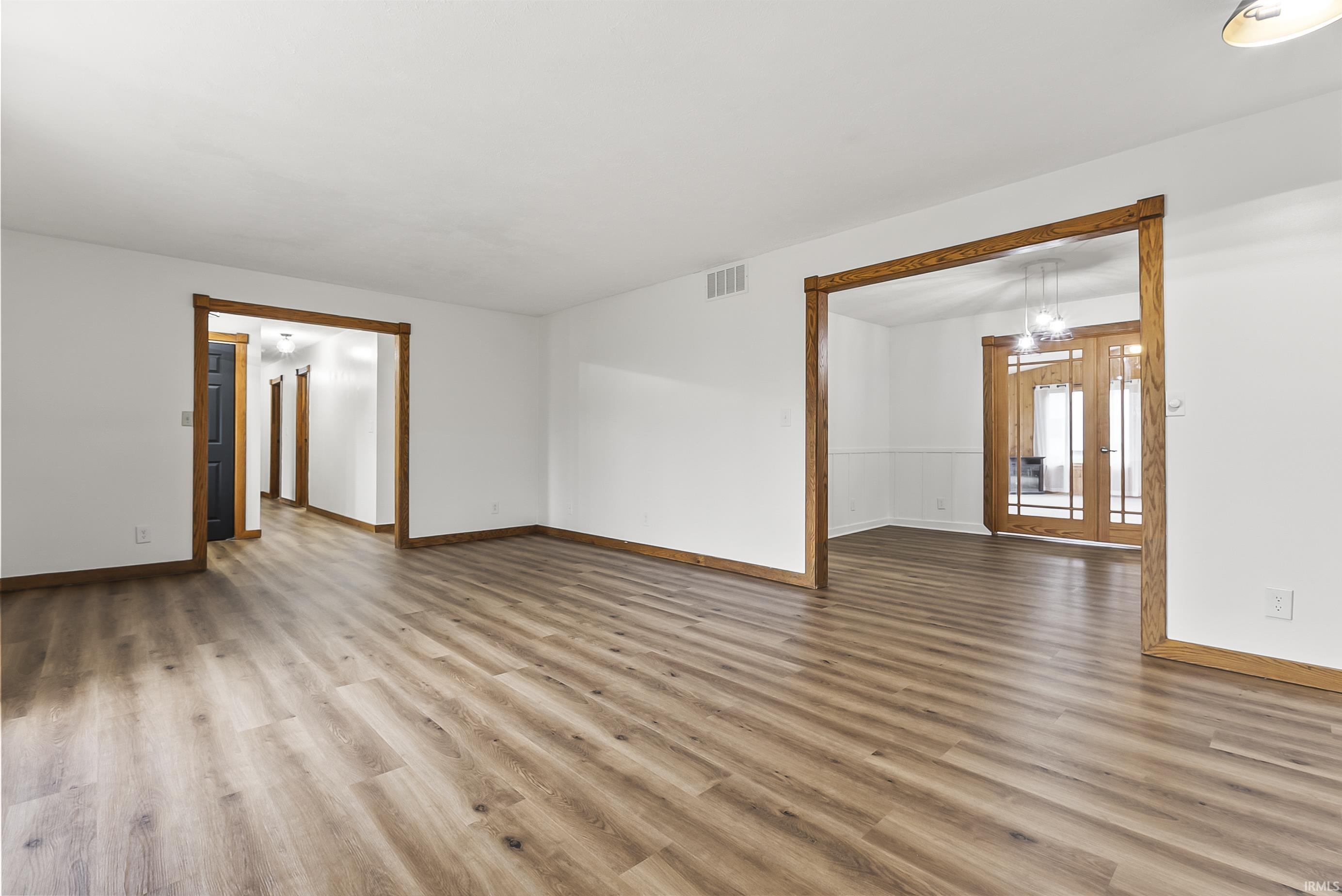 Unfurnished room featuring light wood-style floors and french doors