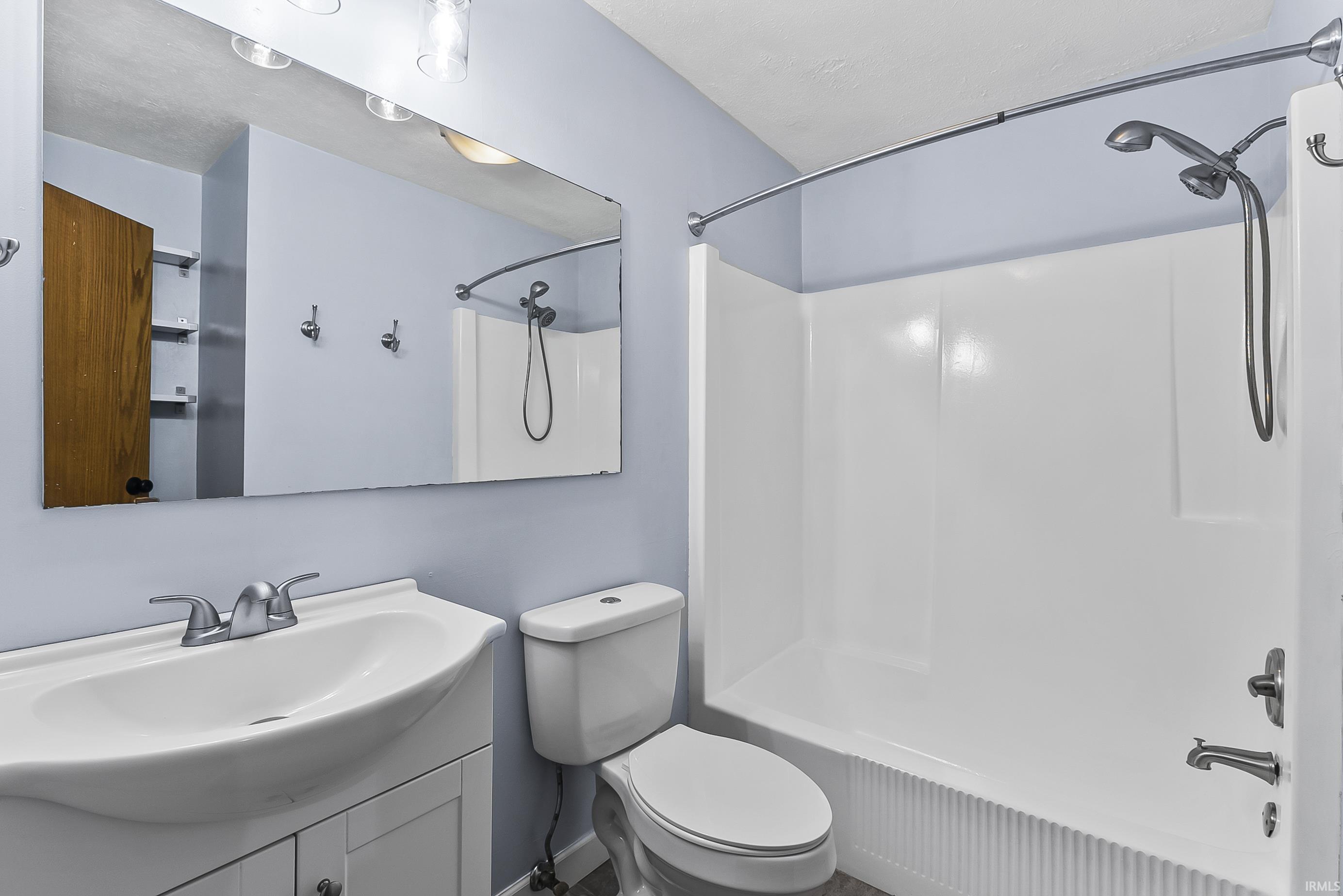 Full bathroom featuring vanity and washtub / shower combination