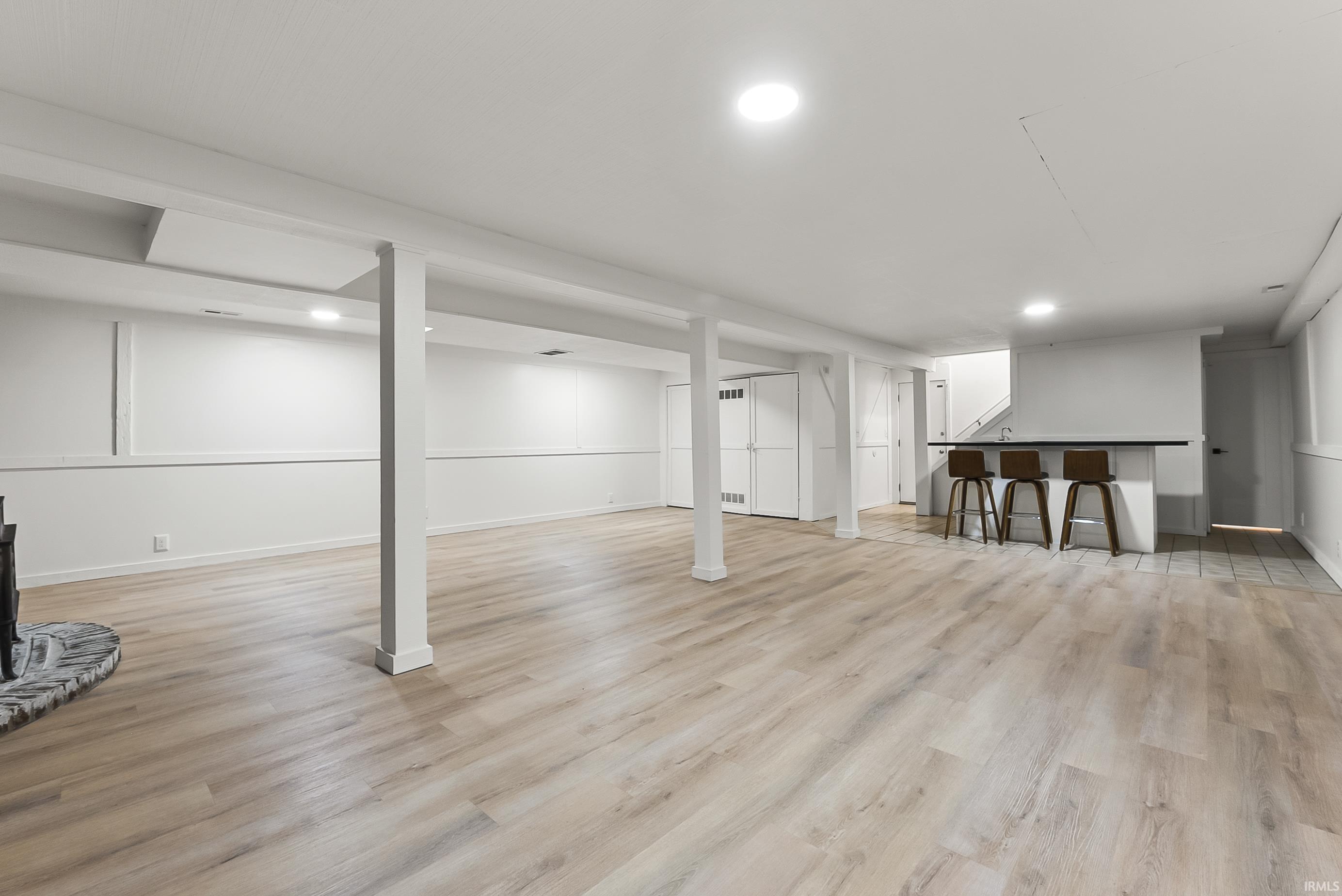 Finished below grade area featuring light wood finished floors and baseboards