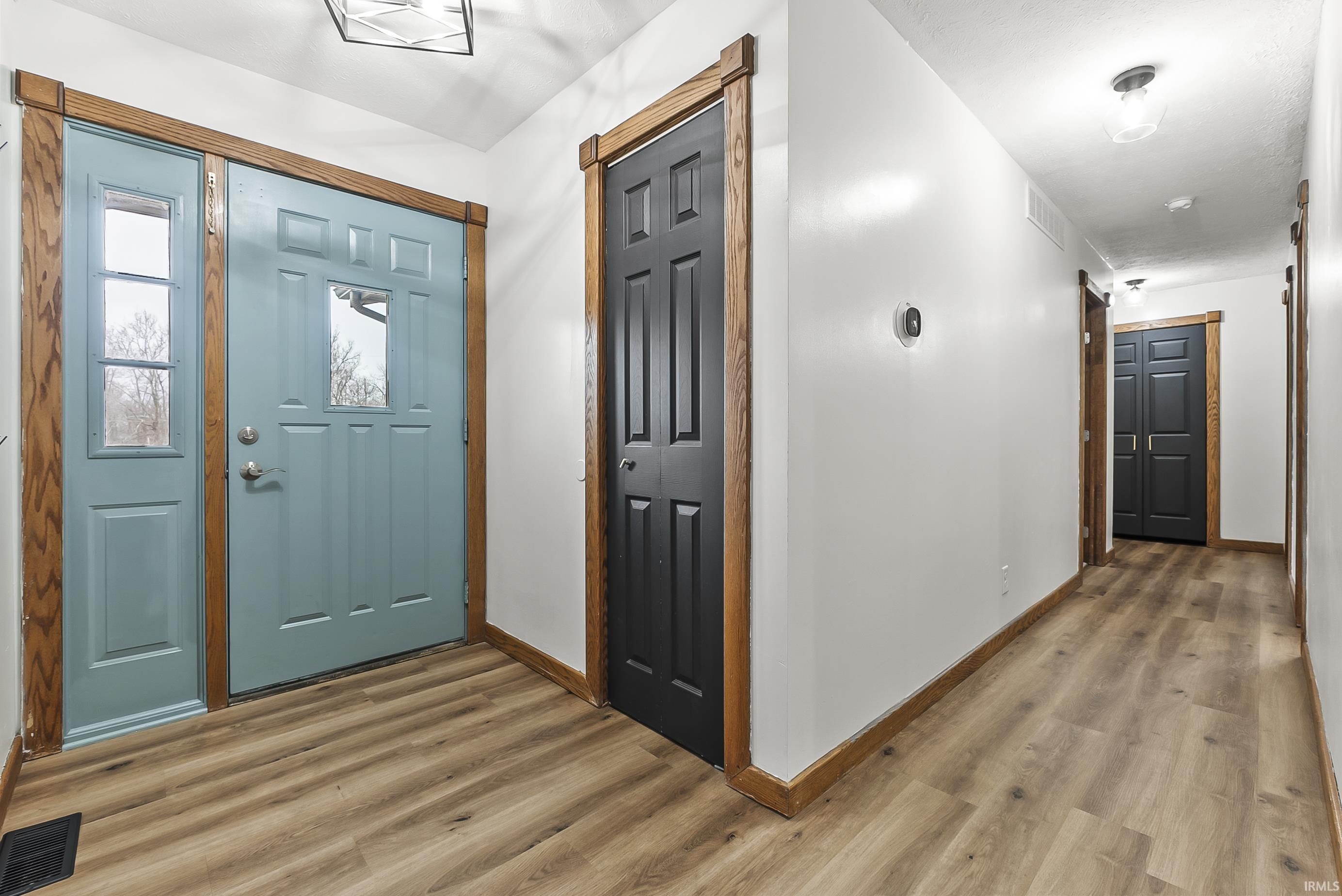 Entrance foyer with wood finished floors