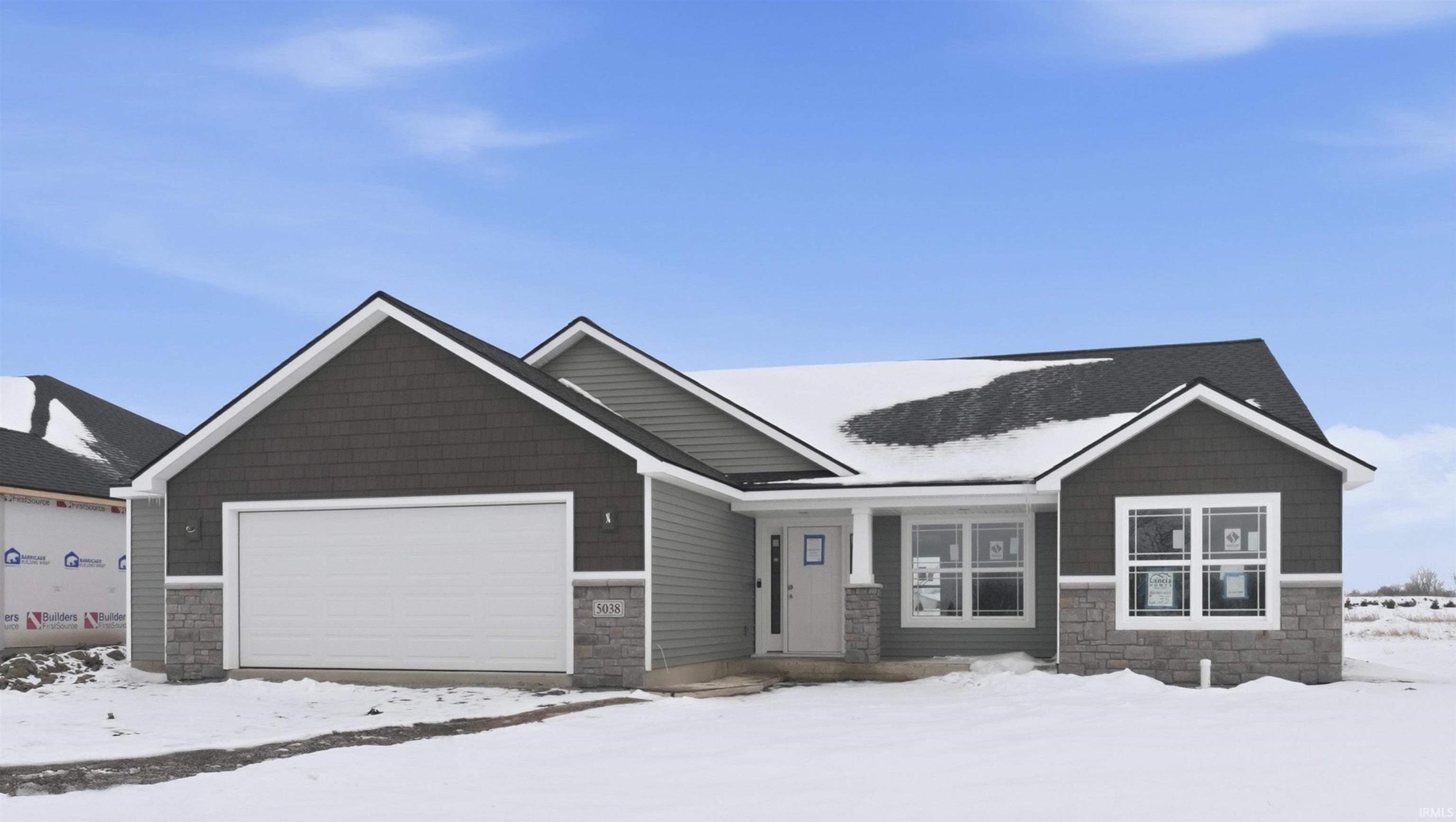 Craftsman inspired home with stone siding and a garage