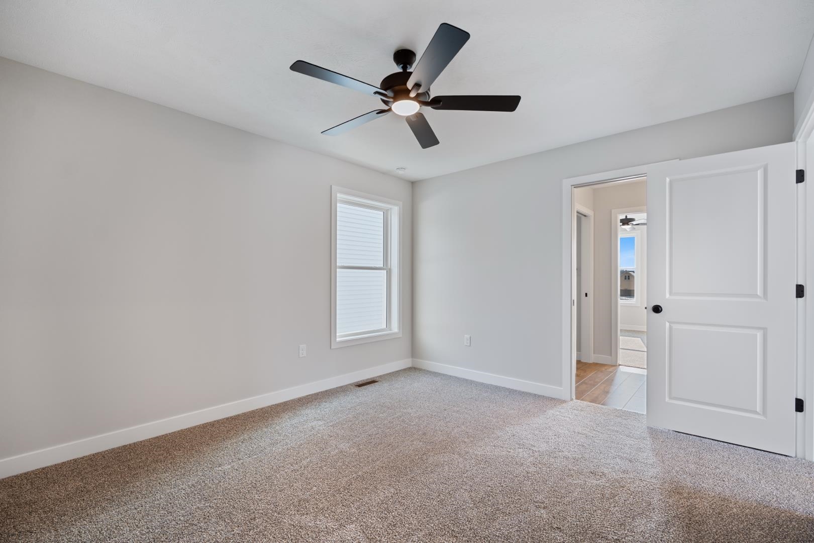 Spare room with light colored carpet and ceiling fan