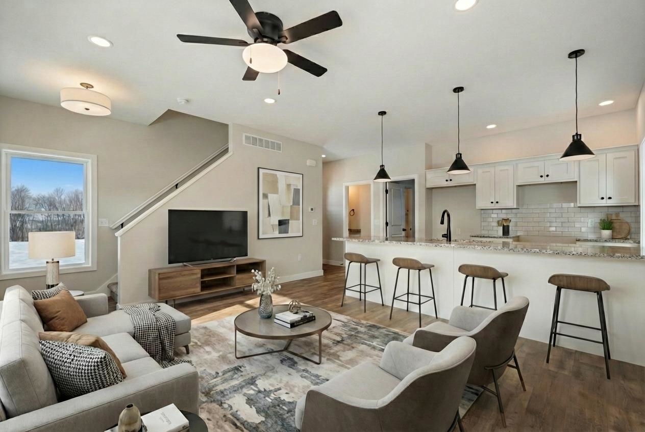 Living area featuring dark wood-style flooring, a ceiling fan, and recessed lighting