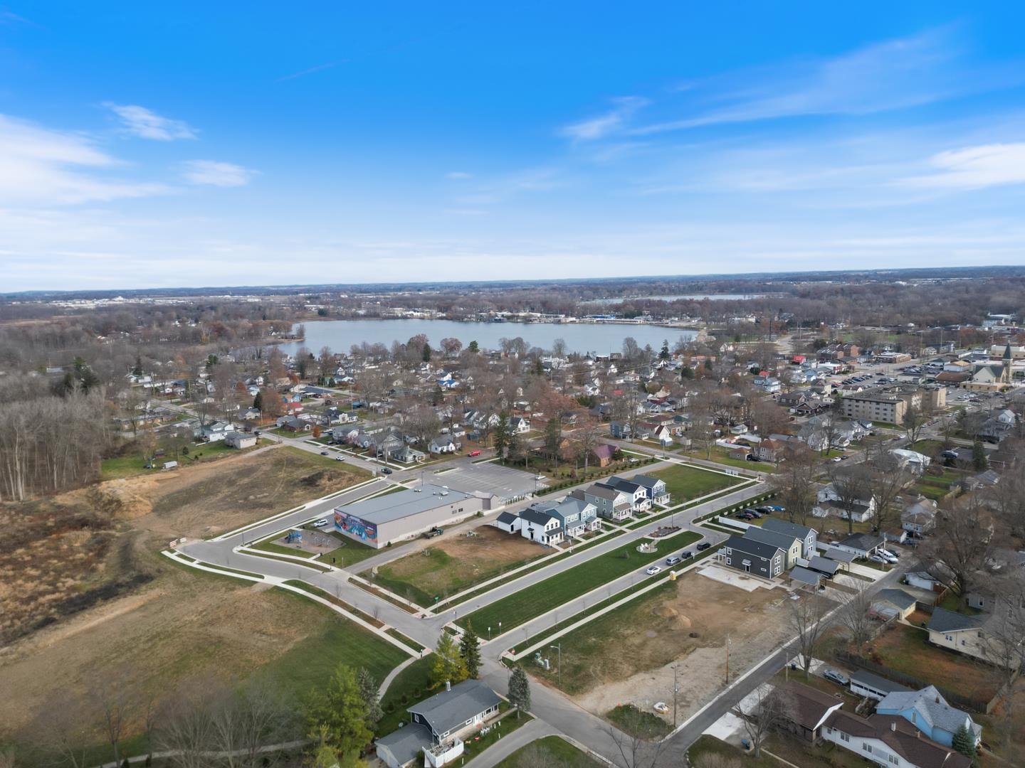Aerial overview of property's location with a nearby body of water and nearby suburban area