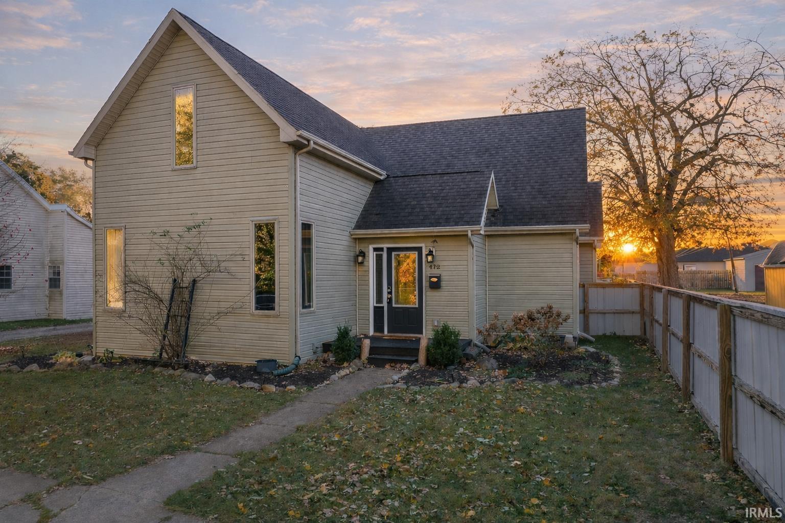 Traditional-style home with roof with shingles