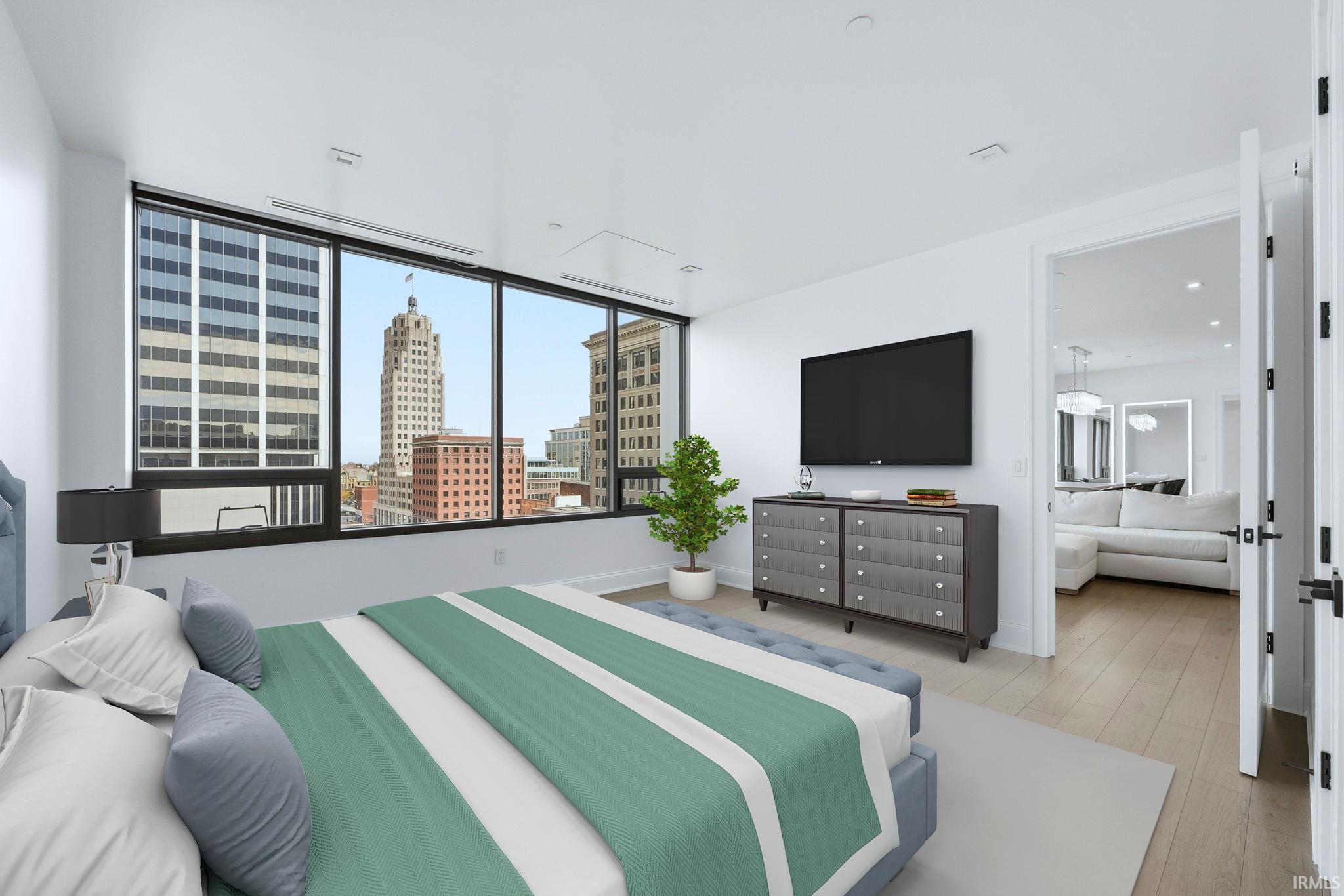 Bedroom featuring light wood-style floors and baseboards
