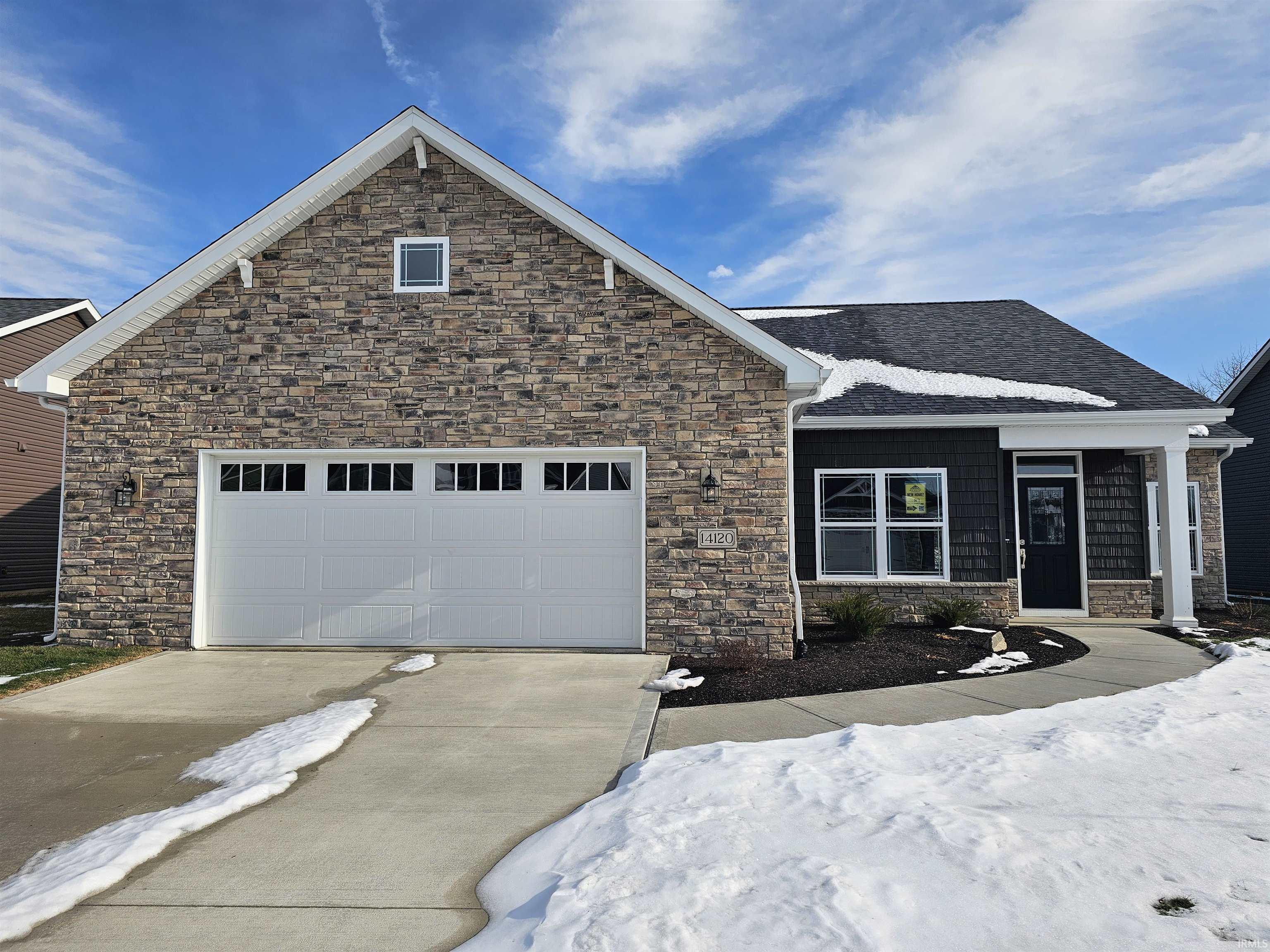 Craftsman inspired home with stone siding, concrete driveway, a garage, and a shingled roof