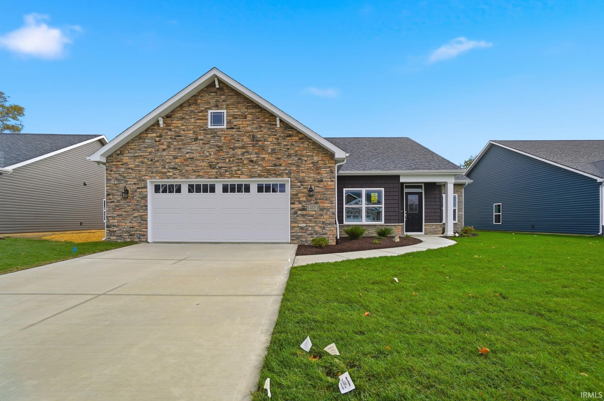 Craftsman inspired home featuring concrete driveway, stone siding, a garage, a front yard, and a shingled roof