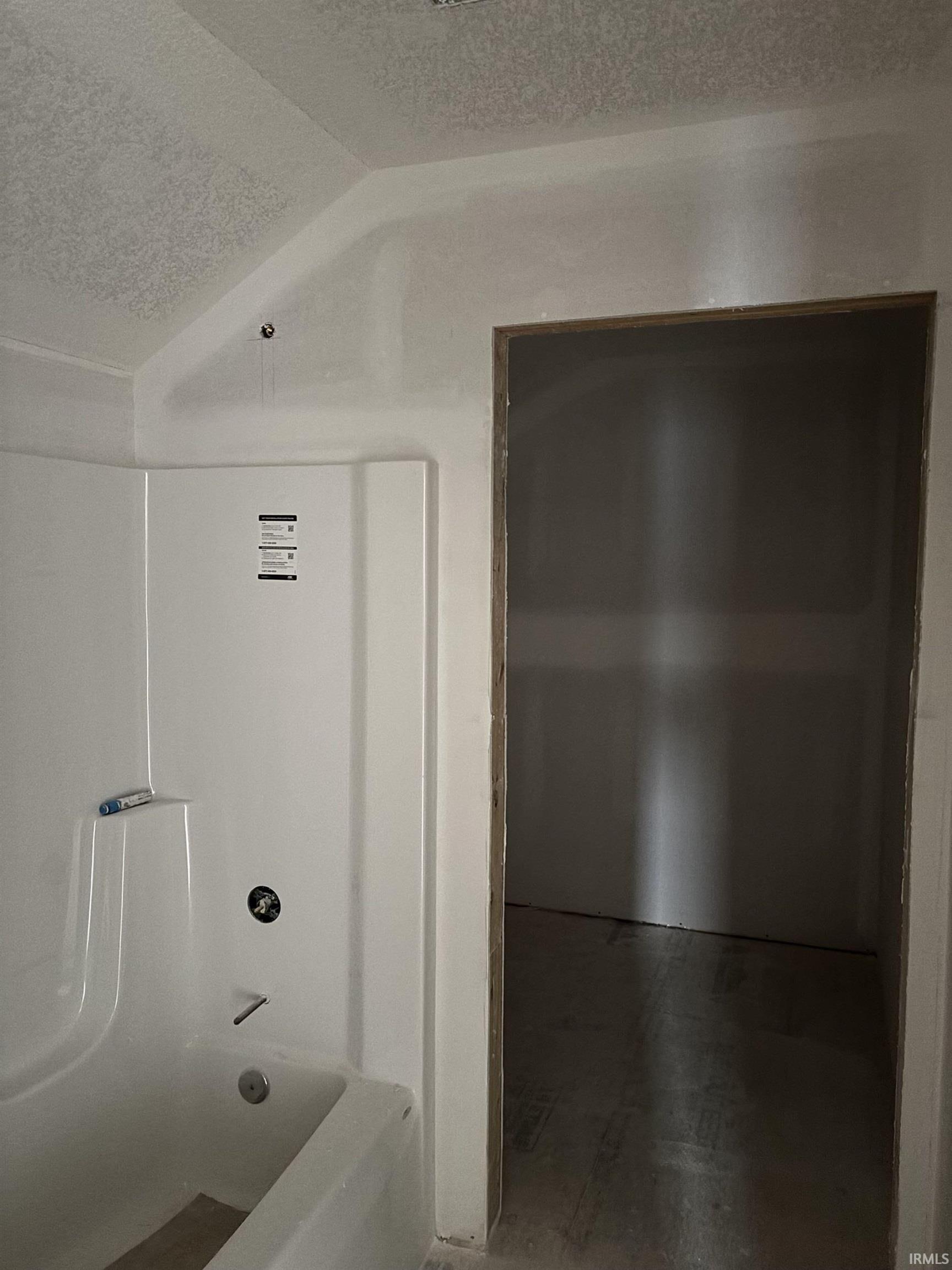 Full bathroom featuring a textured ceiling and shower / bathtub combination