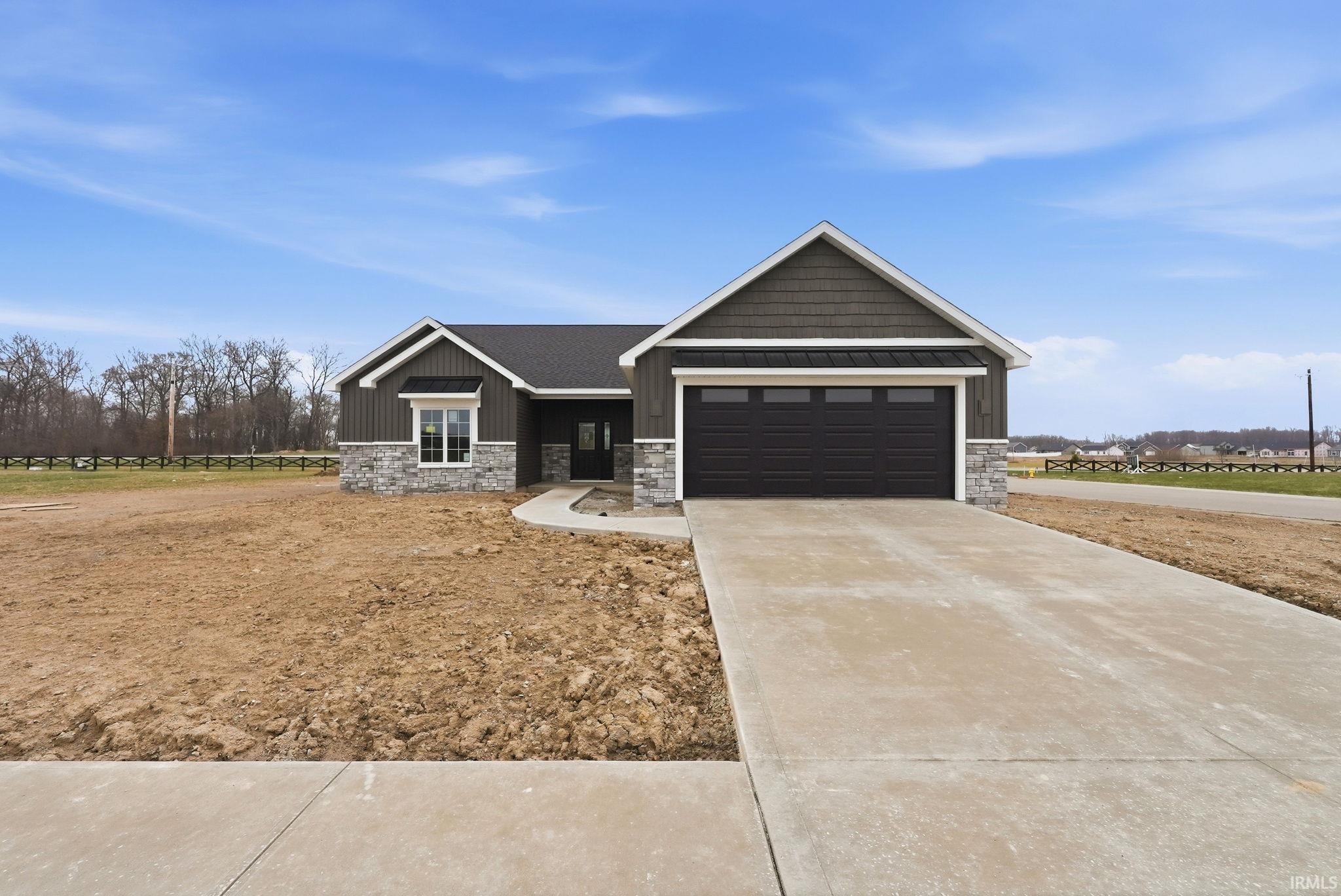 Craftsman house with stone siding, concrete driveway, a garage, and board and batten siding