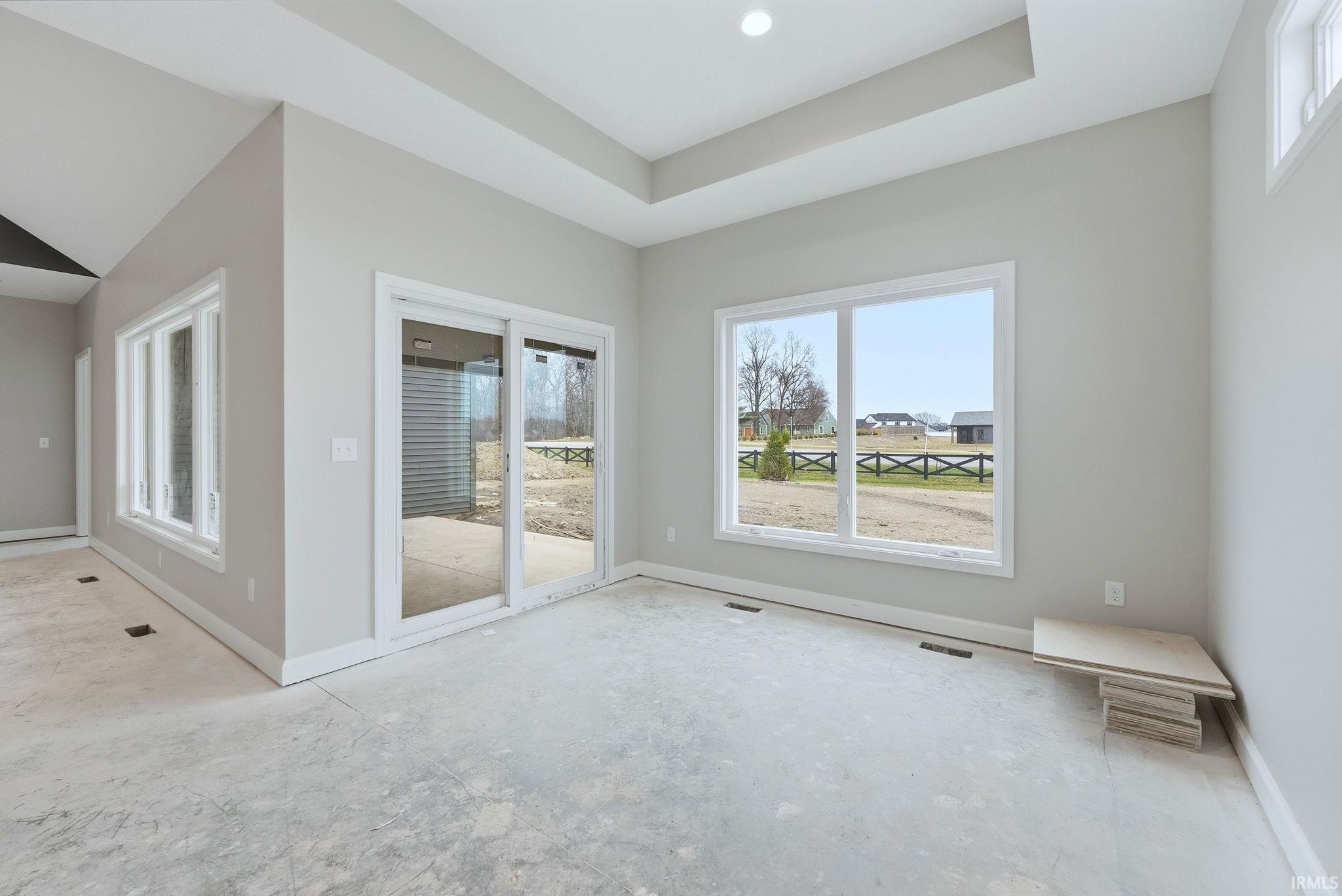 Unfurnished room featuring a raised ceiling