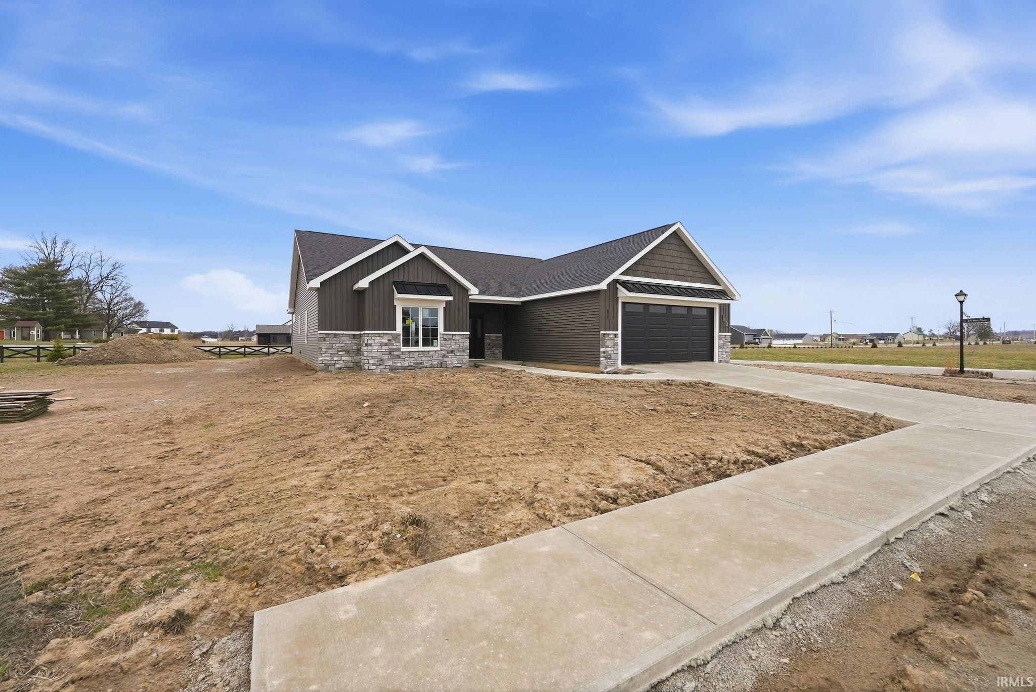 Craftsman house featuring stone siding, concrete driveway, and a garage