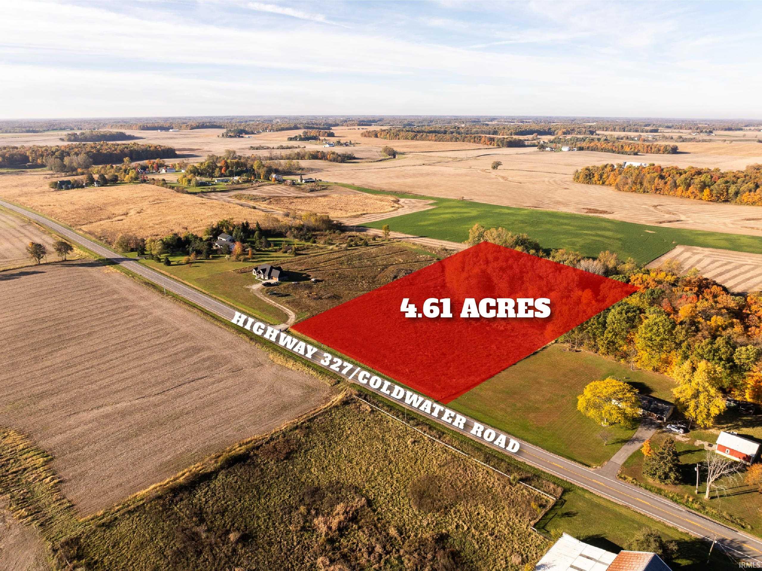 Aerial view of sparsely populated area with property parcel outlined