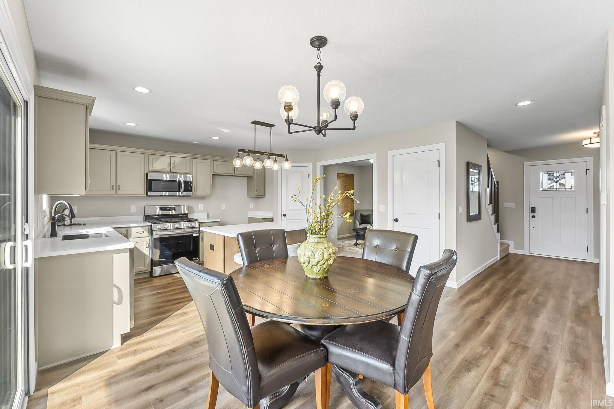 Dining space featuring hanging lights and light wood finished floors