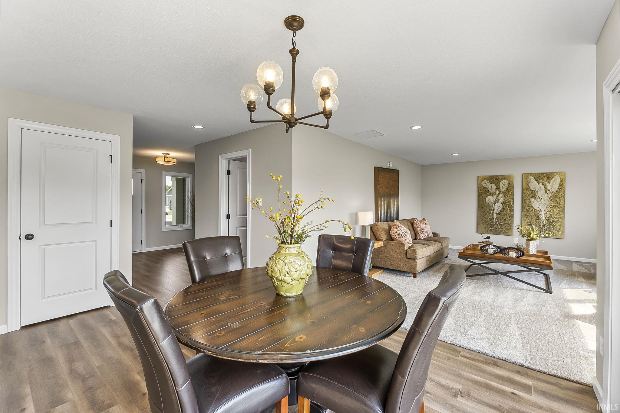 Dining area with hanging lights and wood finished floors