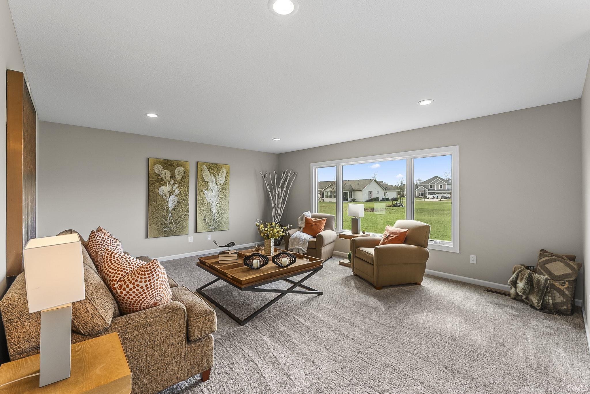 Living area with carpet floors and recessed lighting