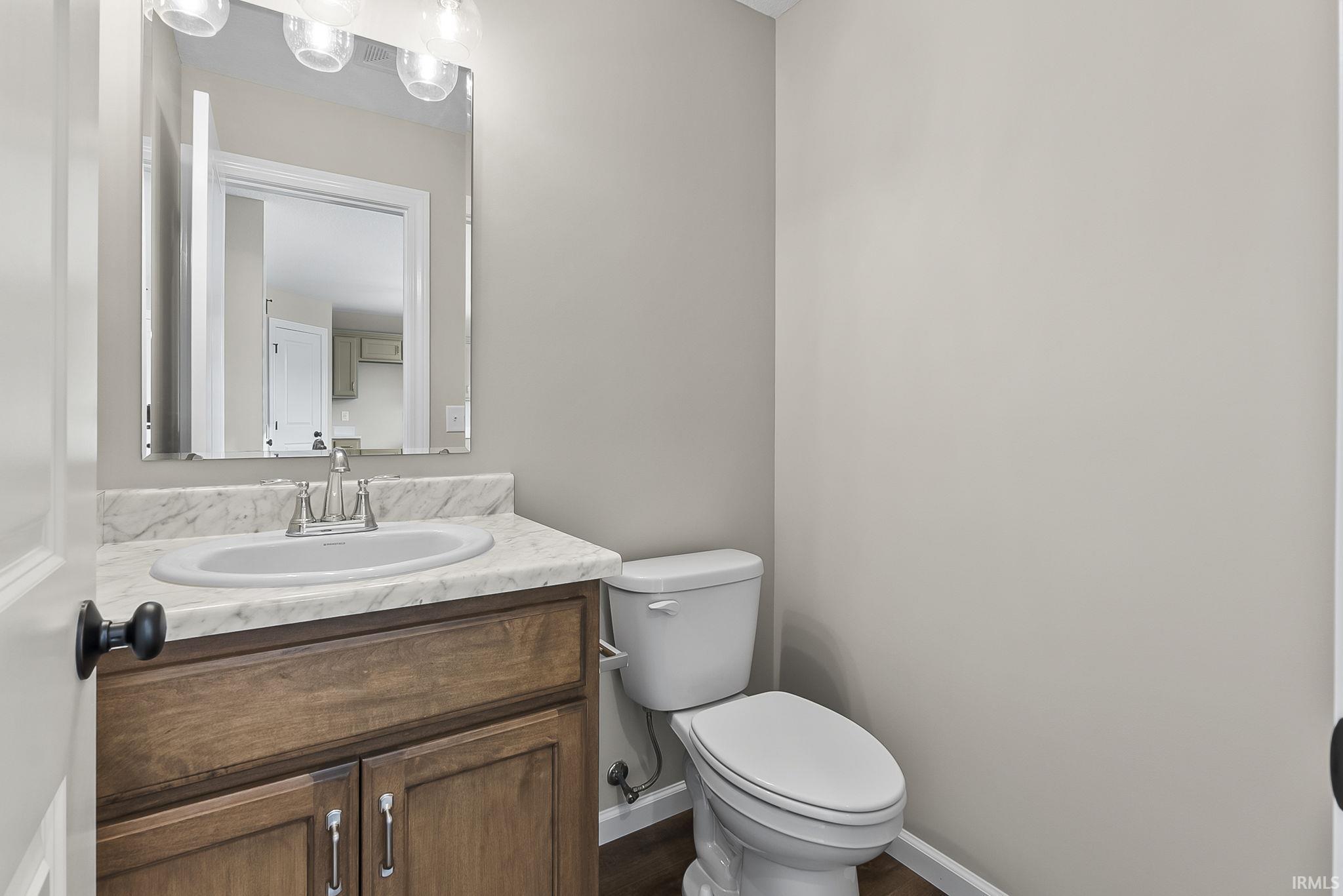 Half bath with vanity and toilet