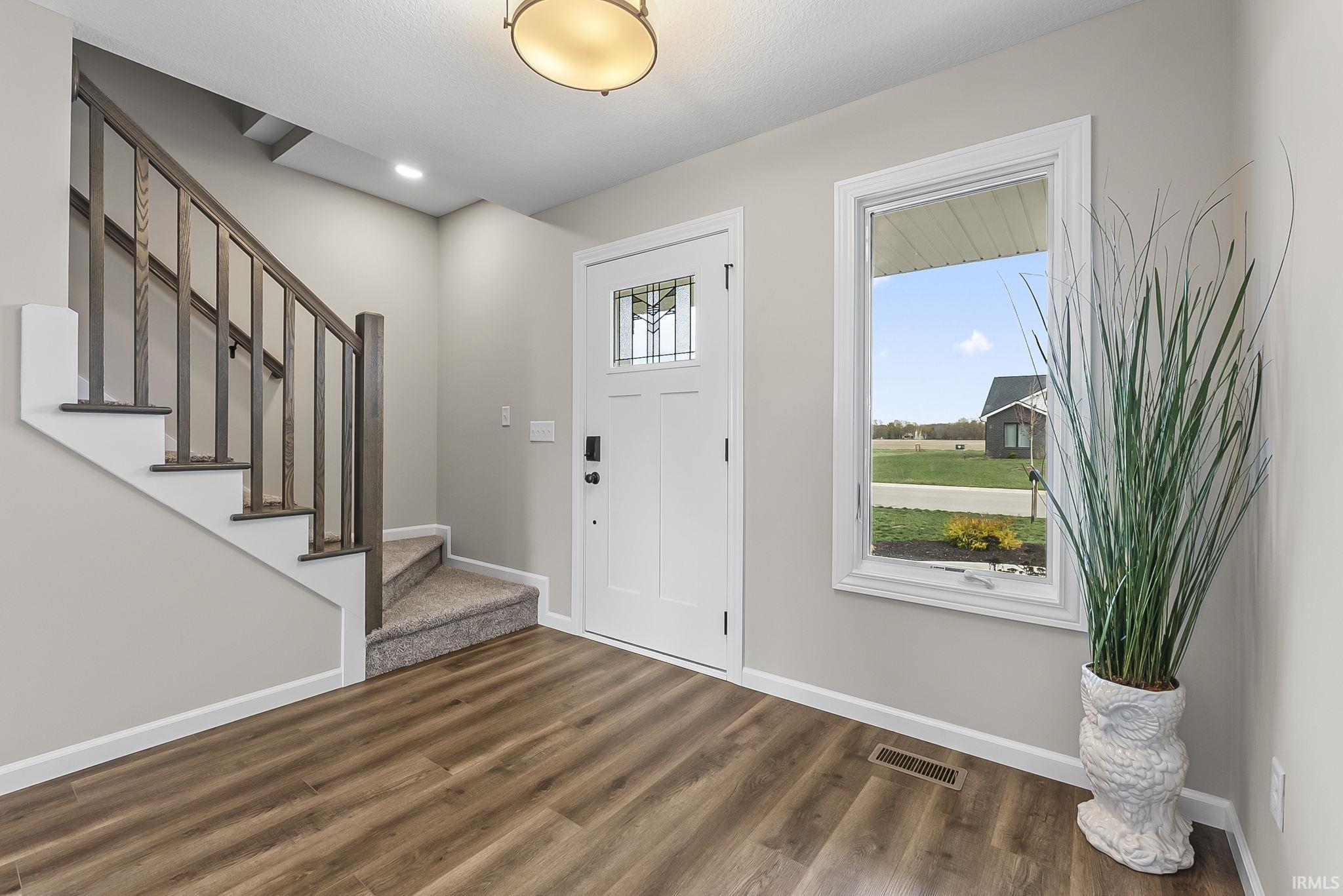 Foyer featuring dark wood-type flooring and recessed lighting