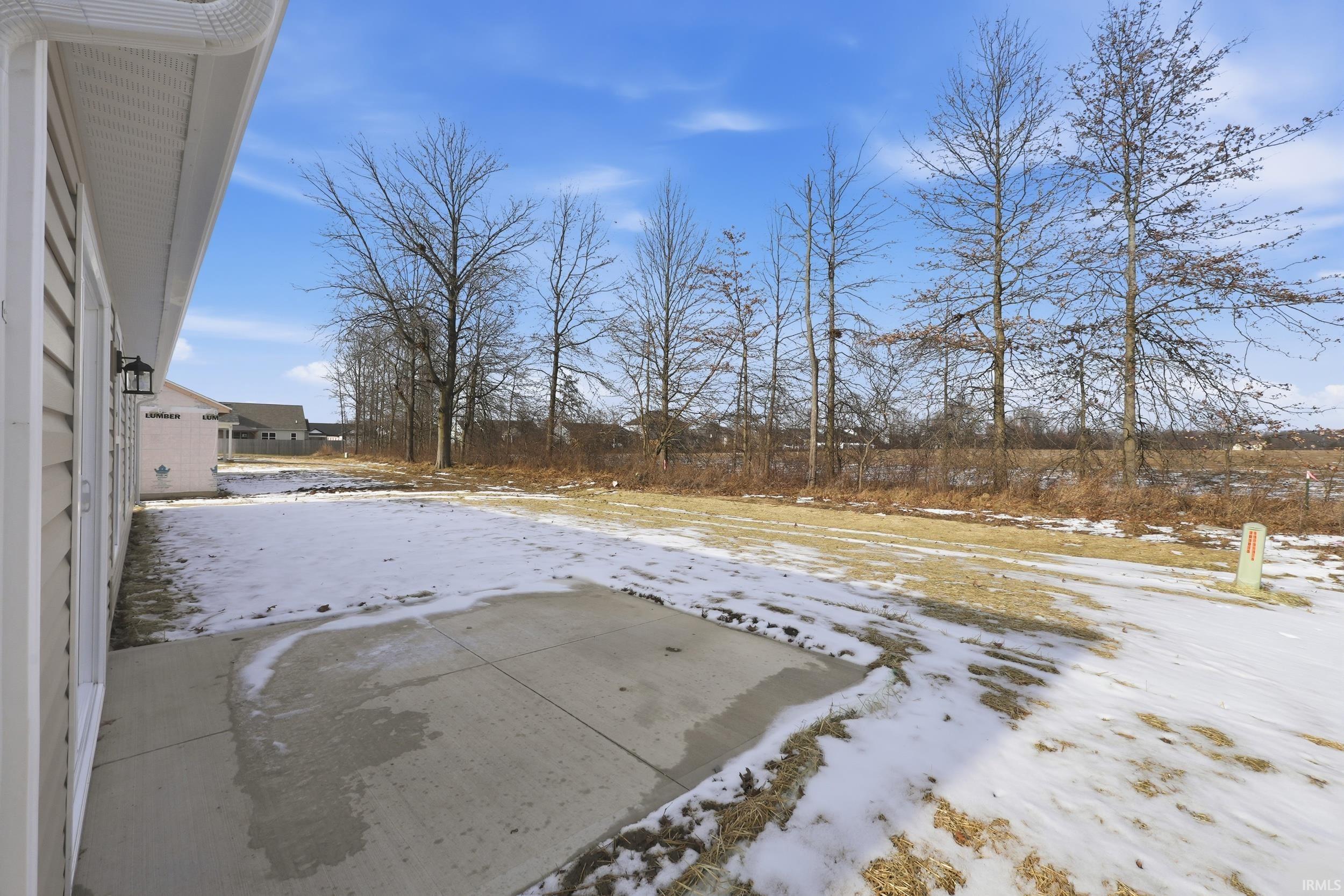Snowy yard with a patio