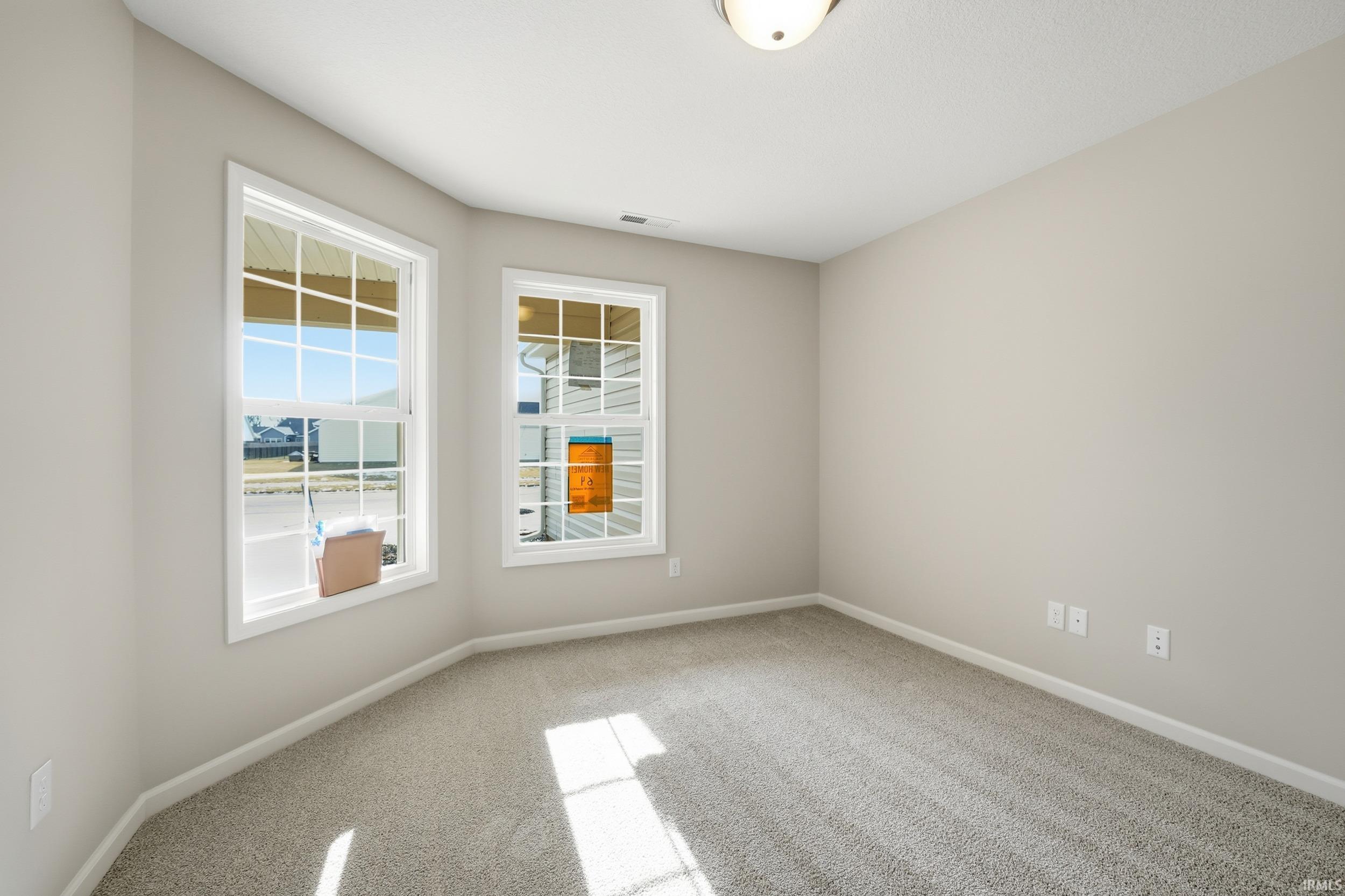 Empty room with light carpet and baseboards