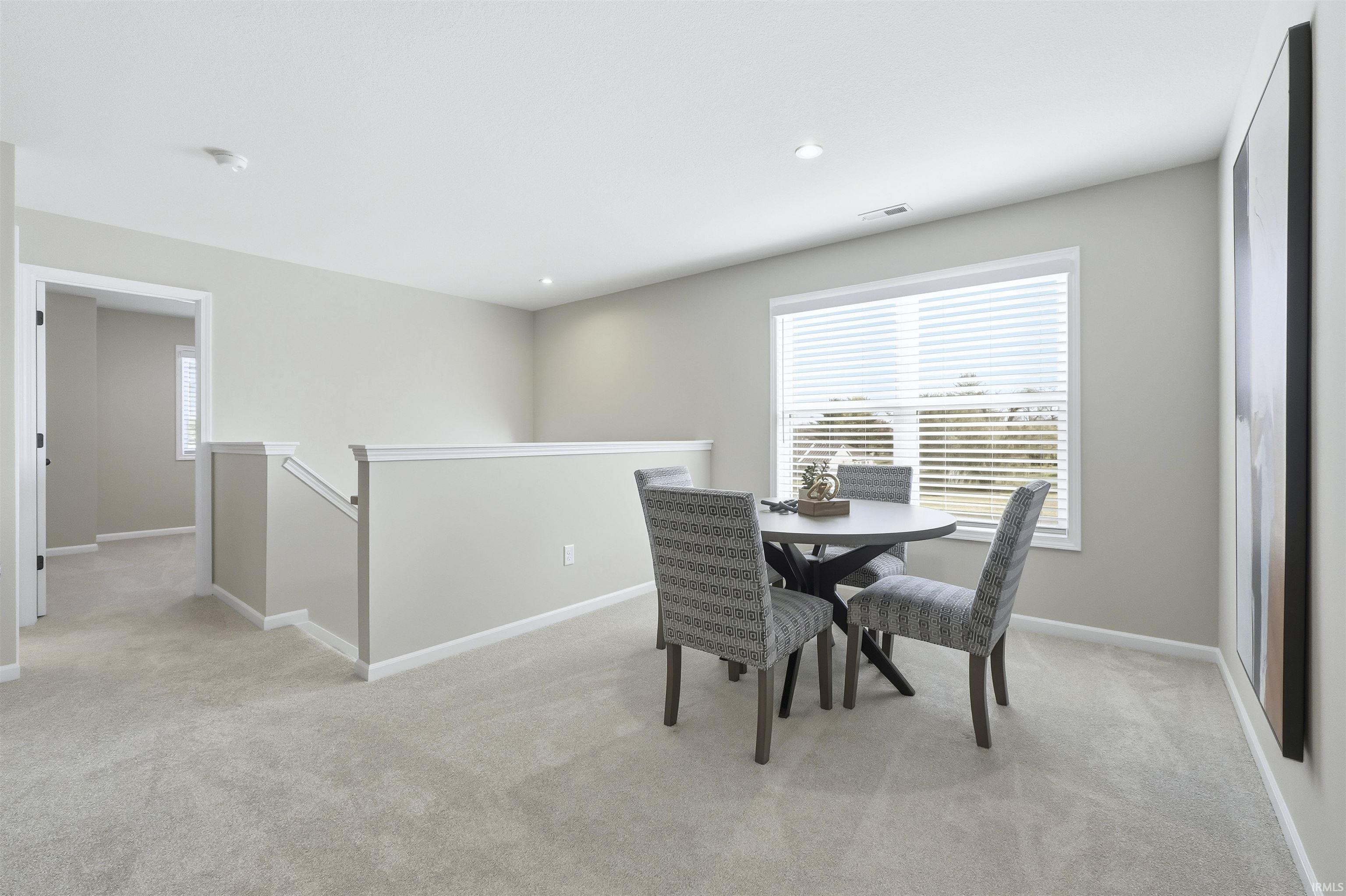Great gaming area in the Loft with light colored carpet and recessed lighting