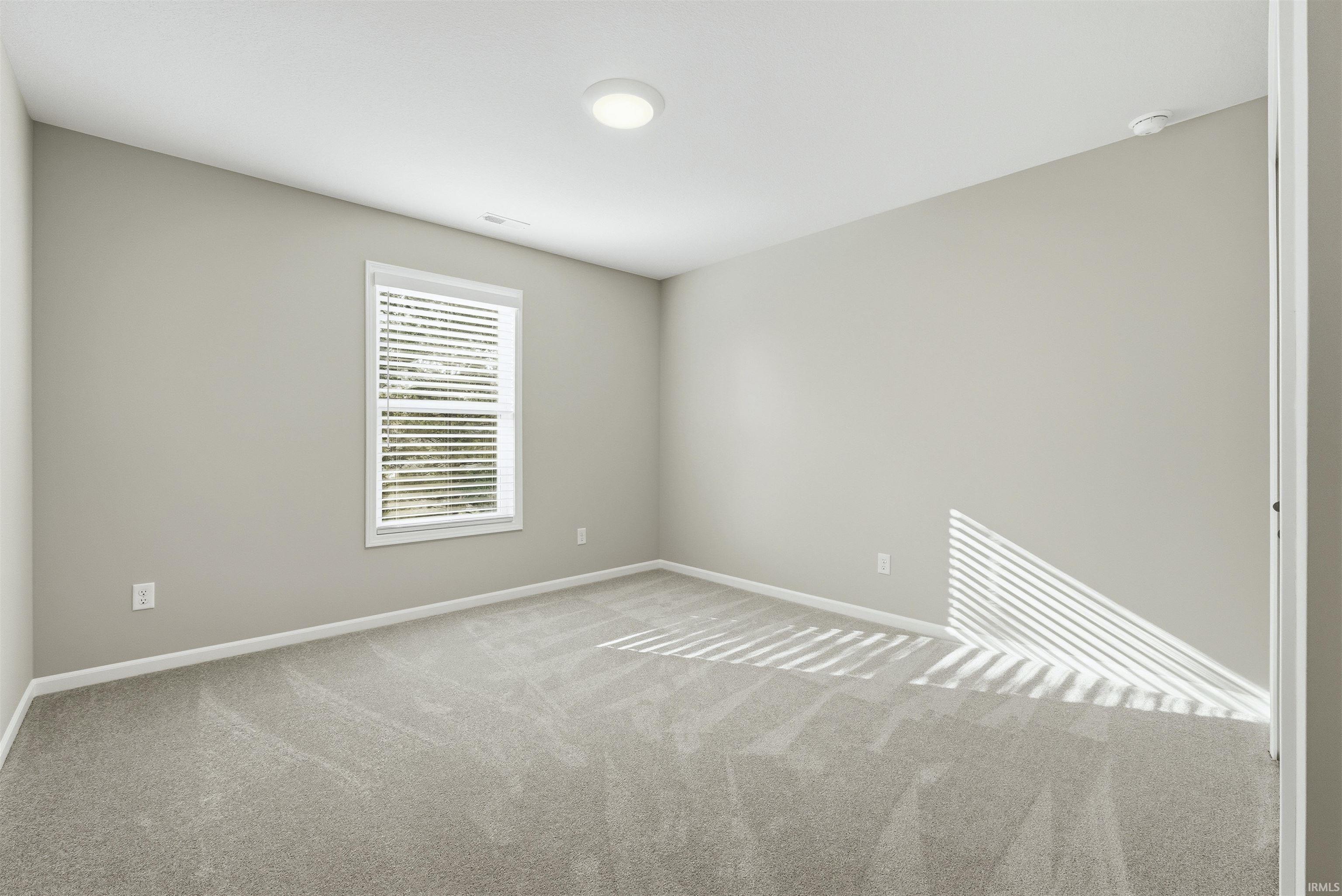 Unfurnished room featuring carpet and baseboards
