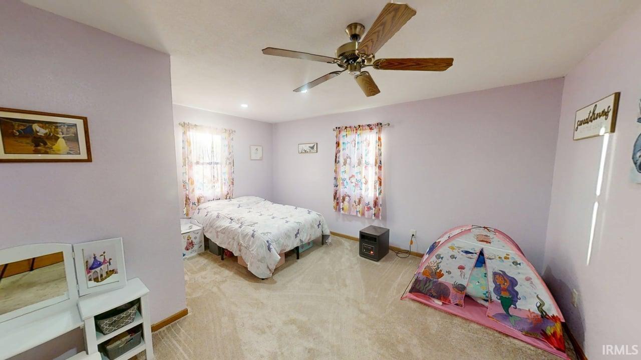 Upstairs Bedroom with carpet flooring and a ceiling fan and closet