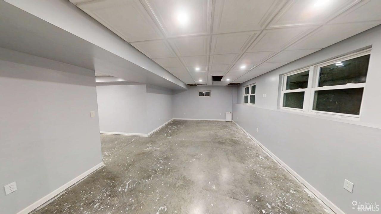 Finished basement featuring windows