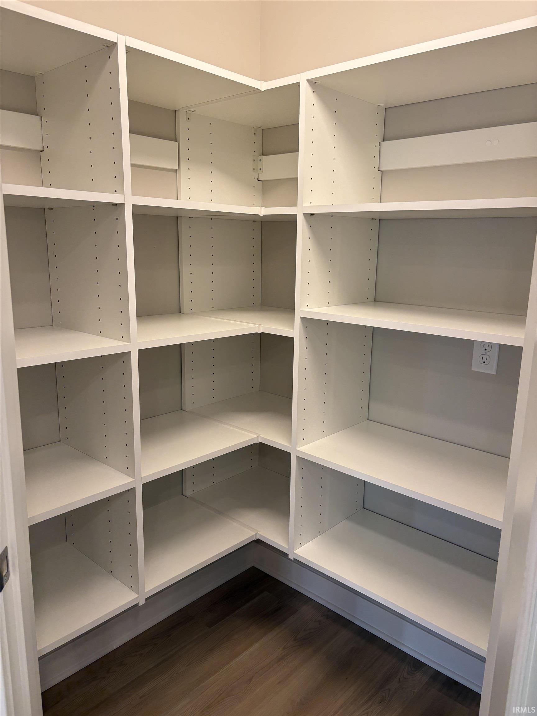 Built-in pantry shelving featuring white finishes and adjustable heights