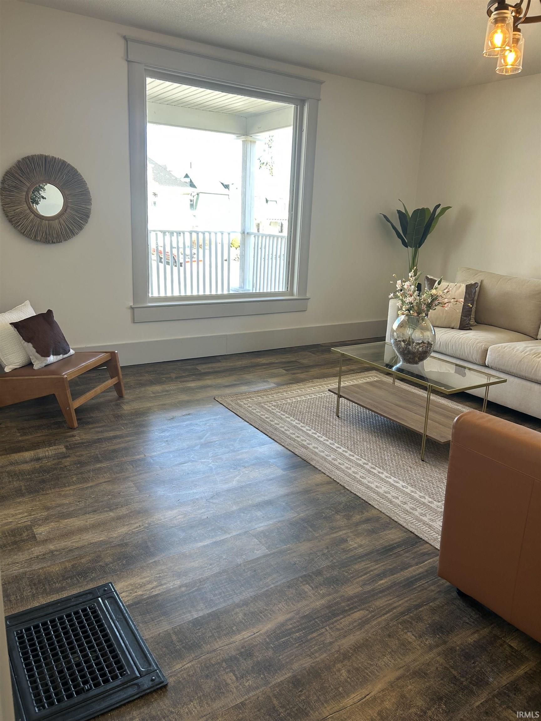 Living room featuring a textured ceiling and baseboards