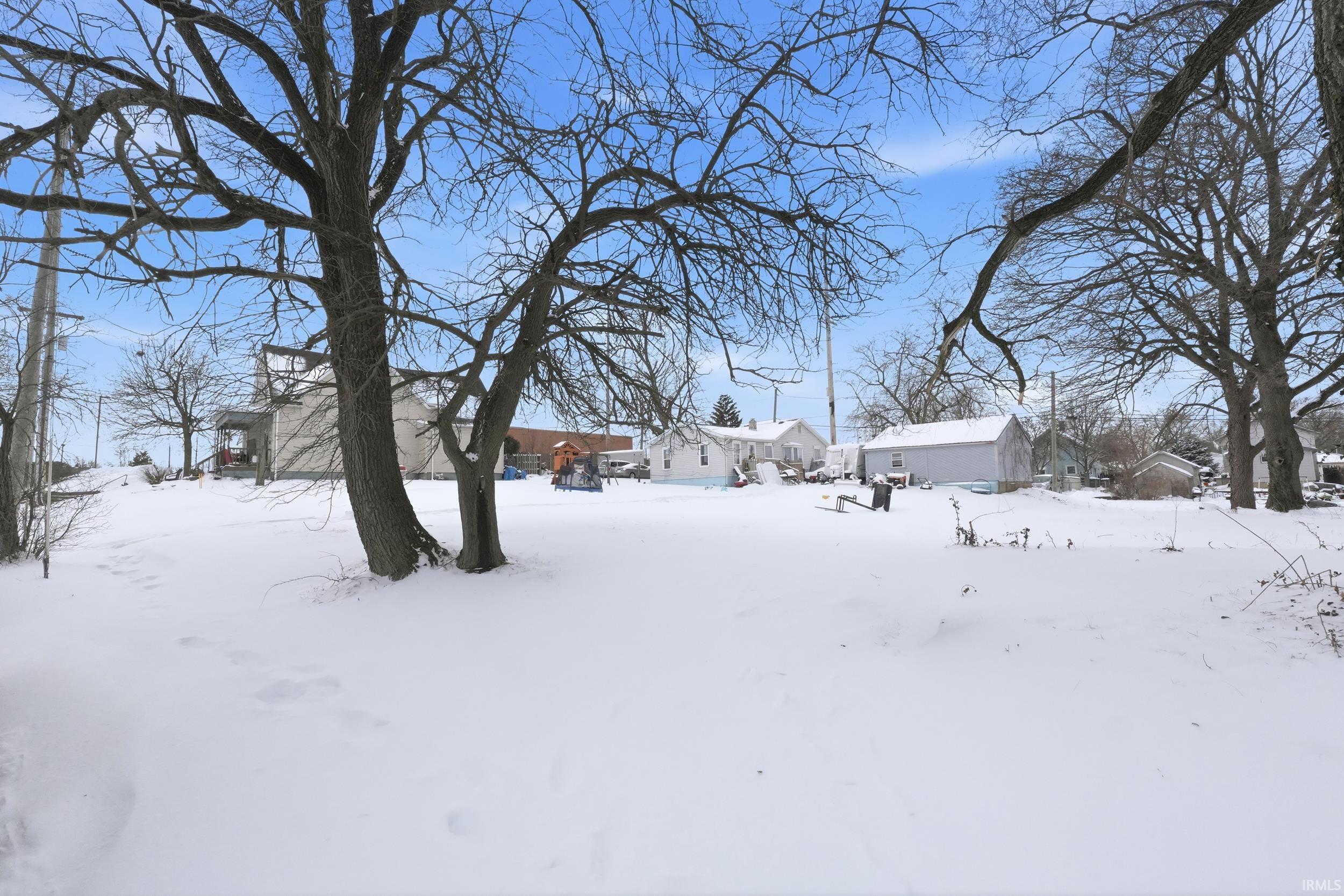 Snowy yard featuring a residential view