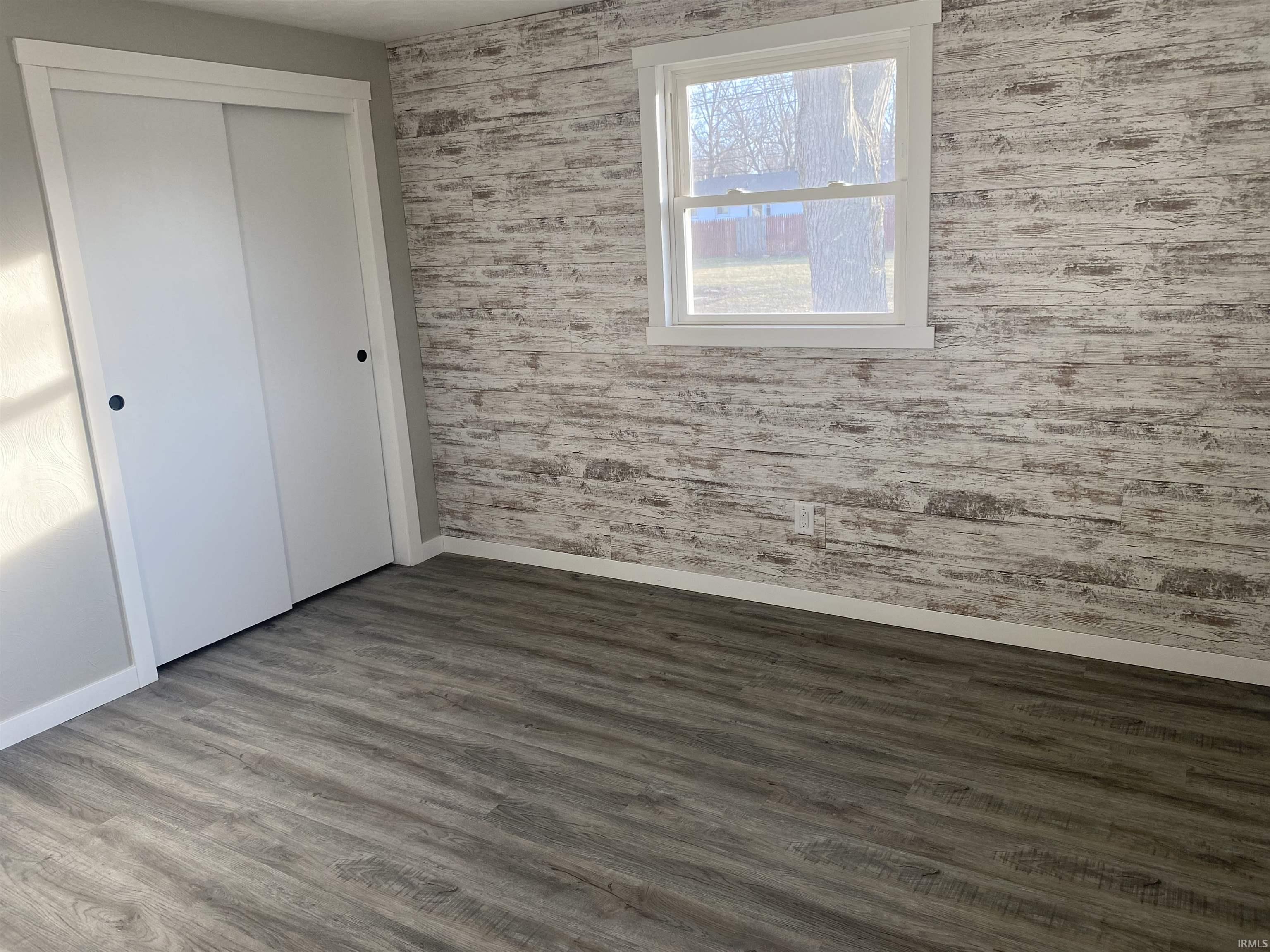 New vinyl plank laminate flooring and accent wall with closet