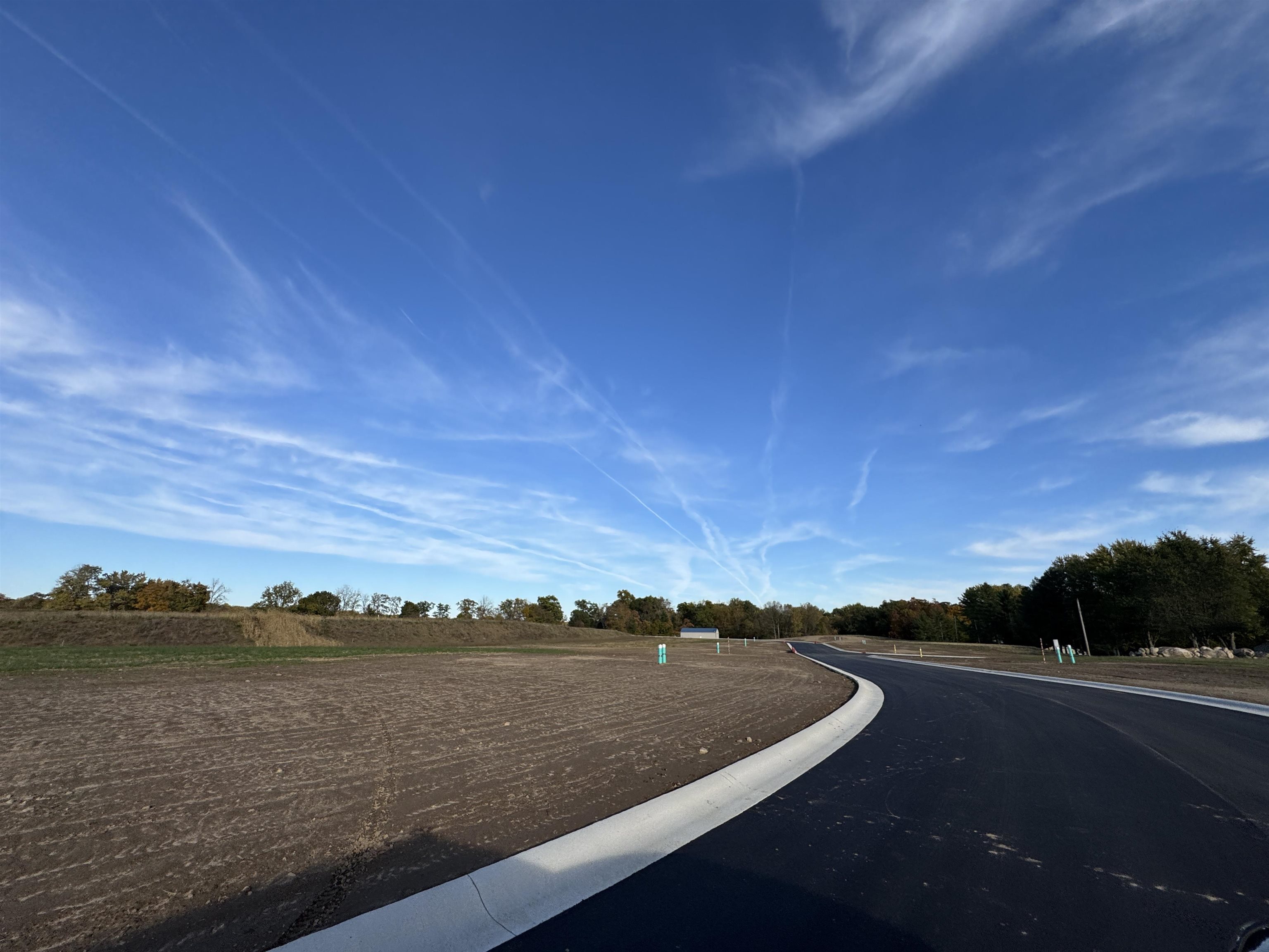 View of asphalt road featuring curbs