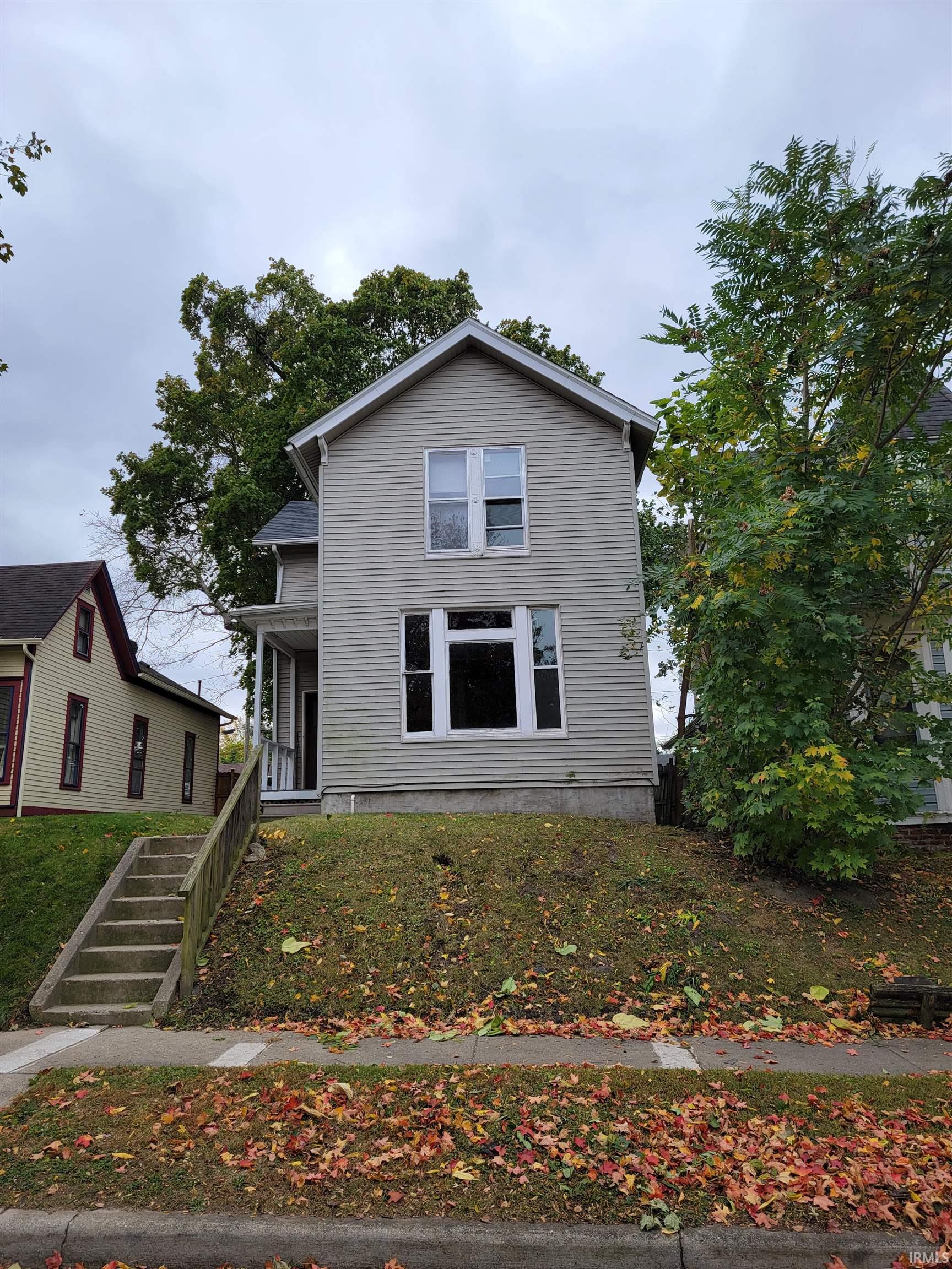 Traditional-style house featuring covered porch