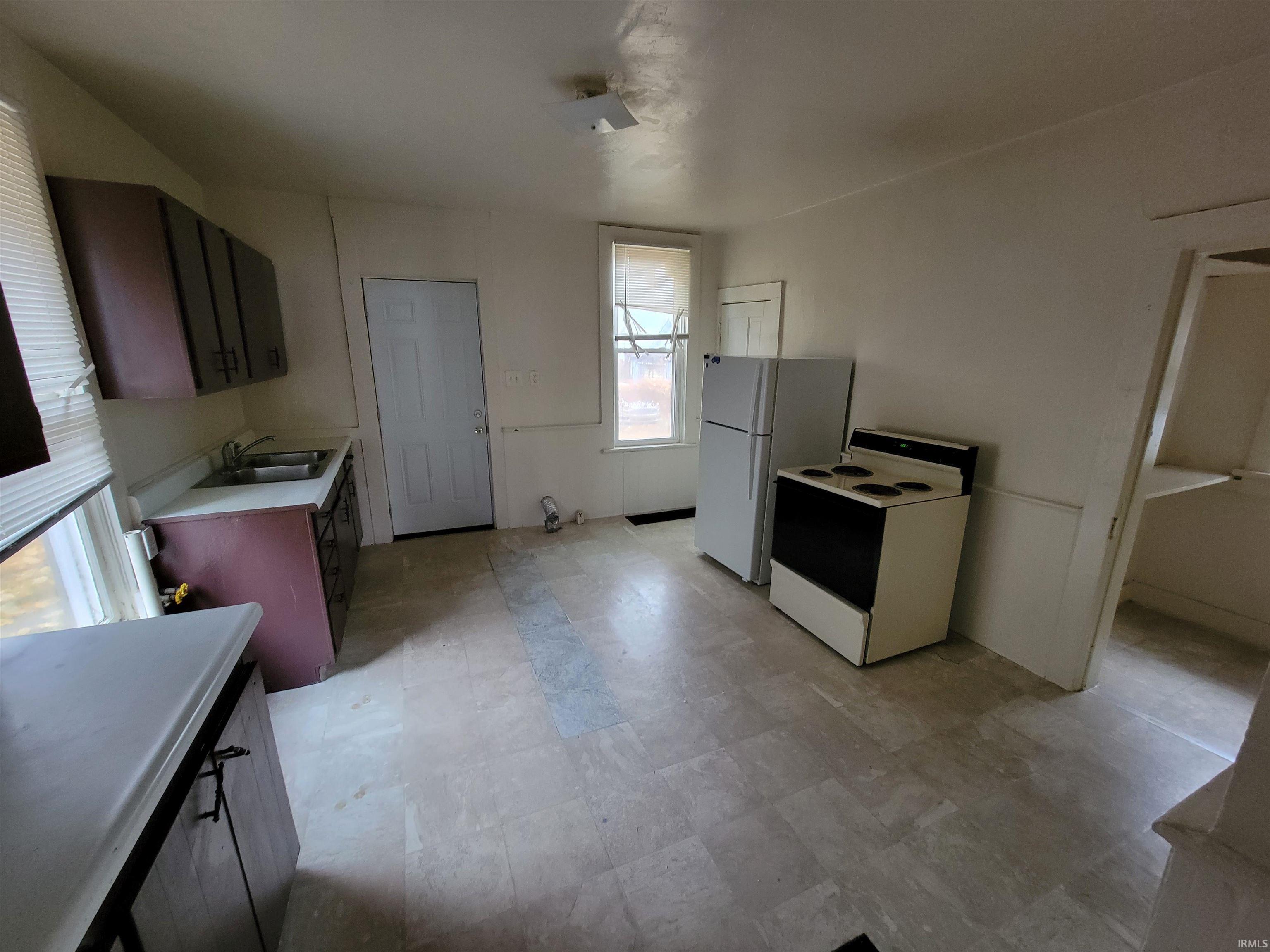 Kitchen featuring light countertops and white appliances