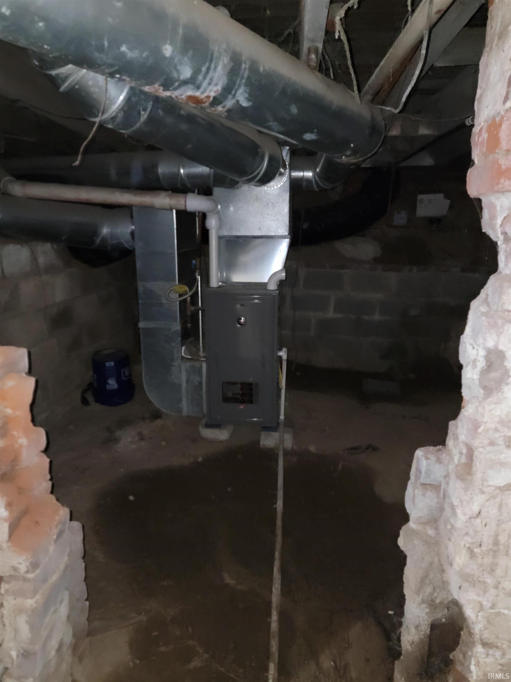 Unfinished below grade area with heating unit