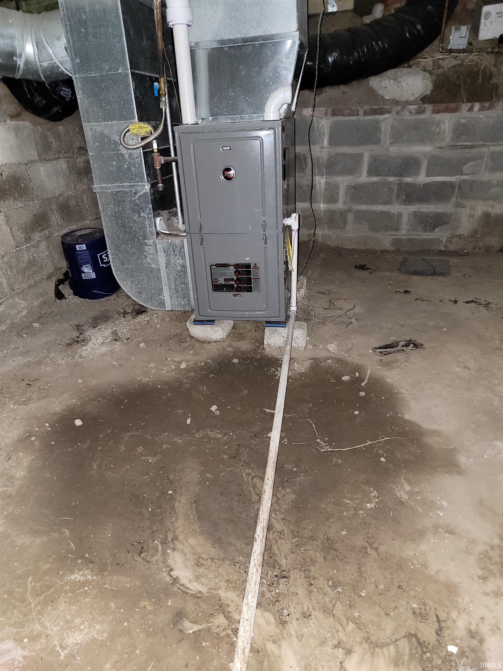 Utility room featuring heating unit