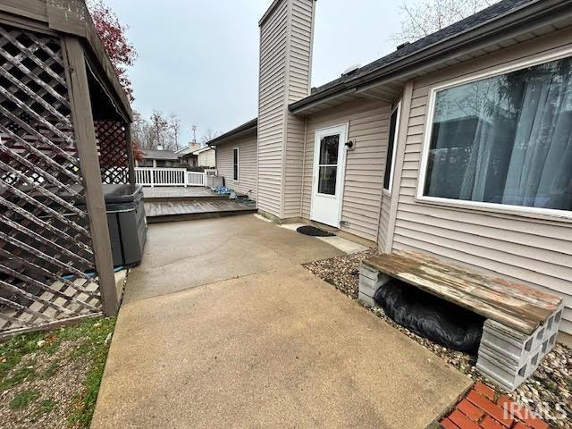 View of home's exterior featuring a deck and a chimney