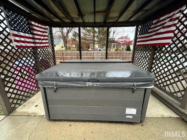 View of patio with a hot tub