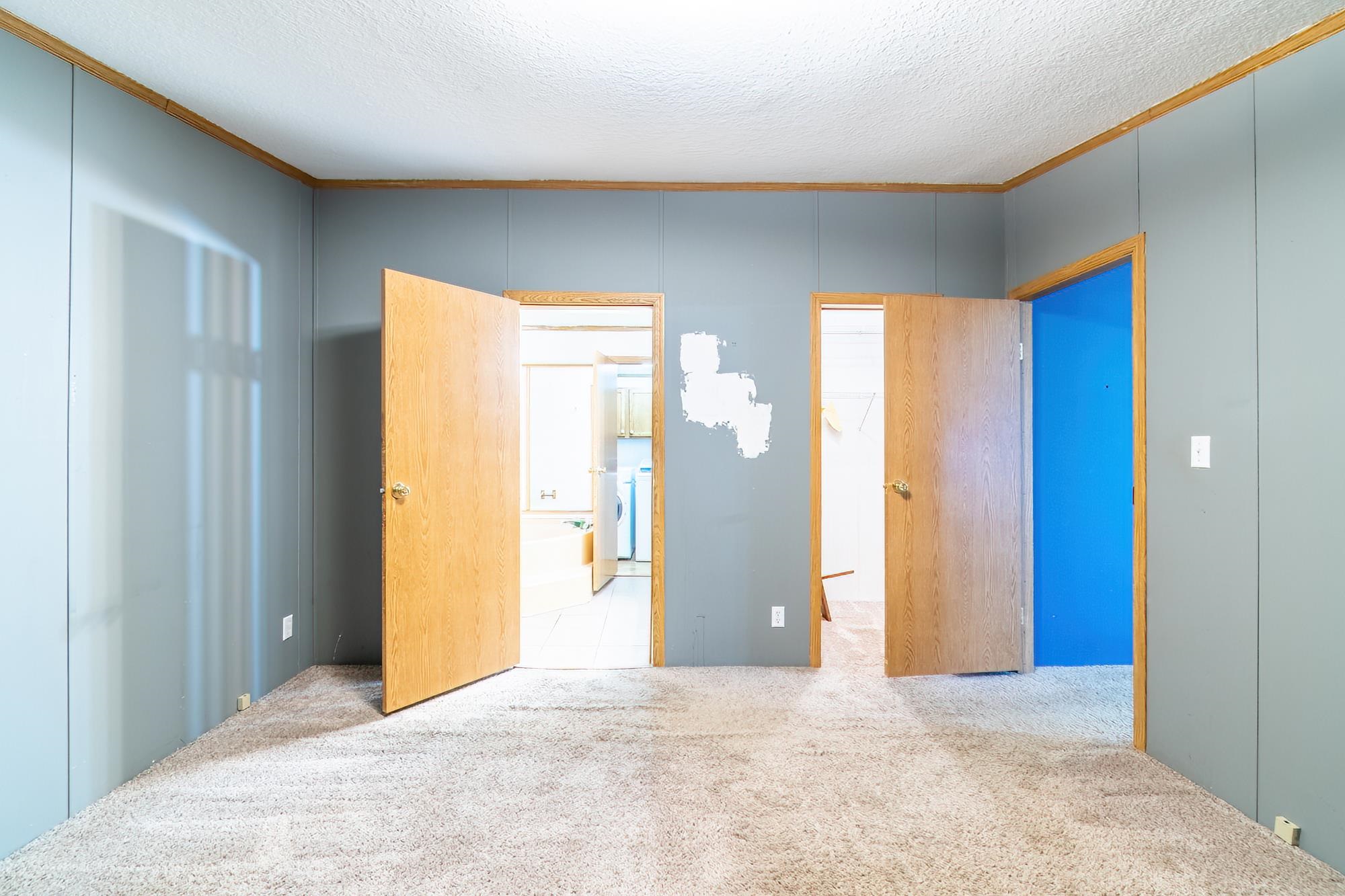 Unfurnished bedroom with ornamental molding, carpet floors, and a textured ceiling