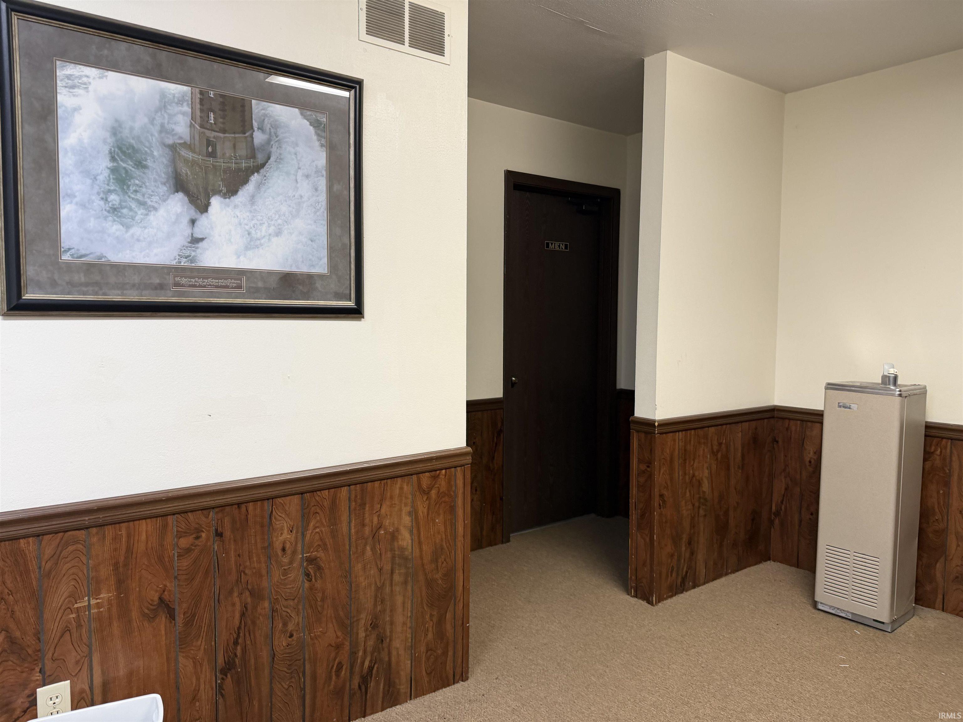 Hallway to bathrooms, drinking fountain and coat rack area at the East entryway
