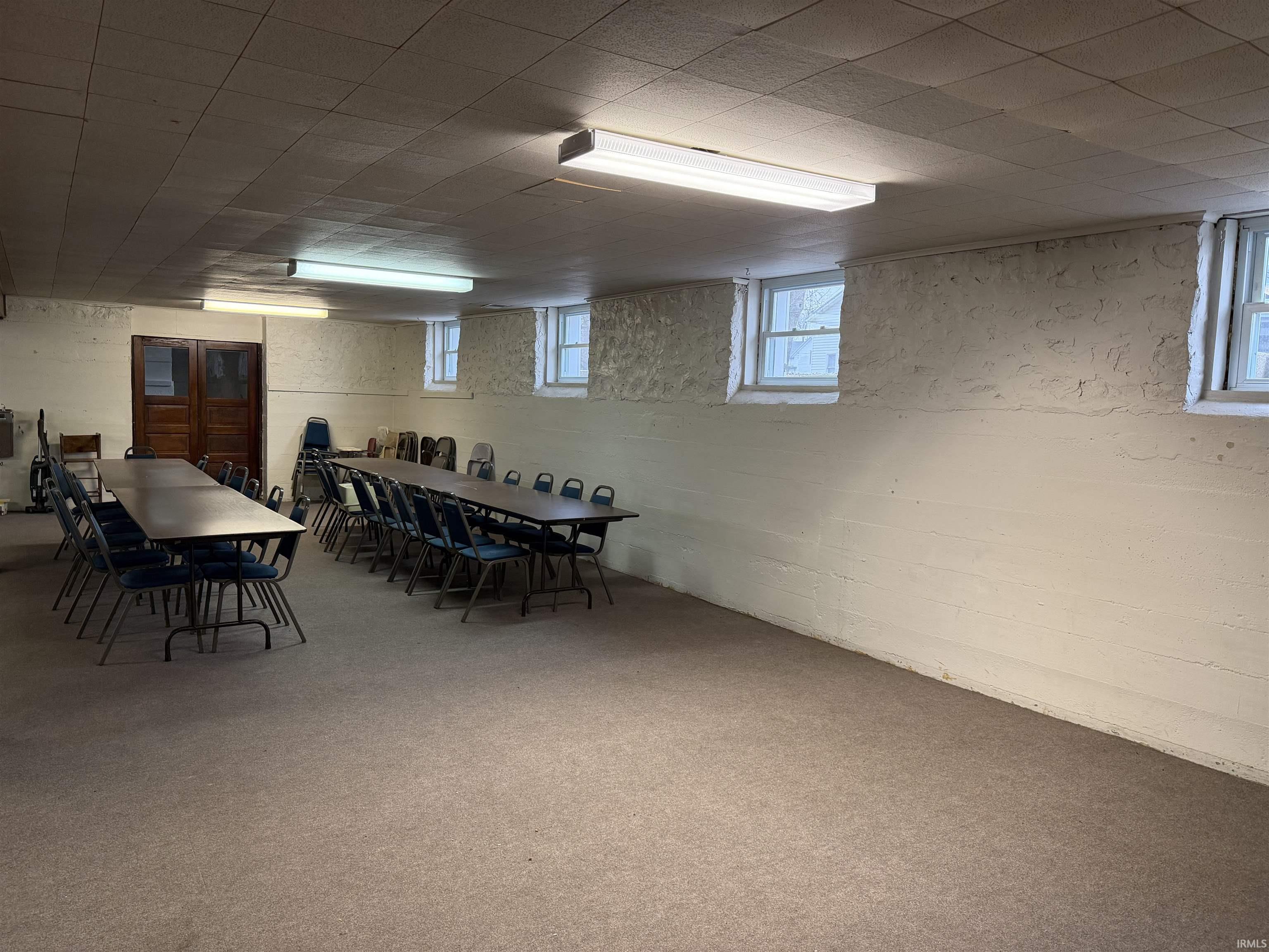 Dining room featuring concrete block wall, carpeting