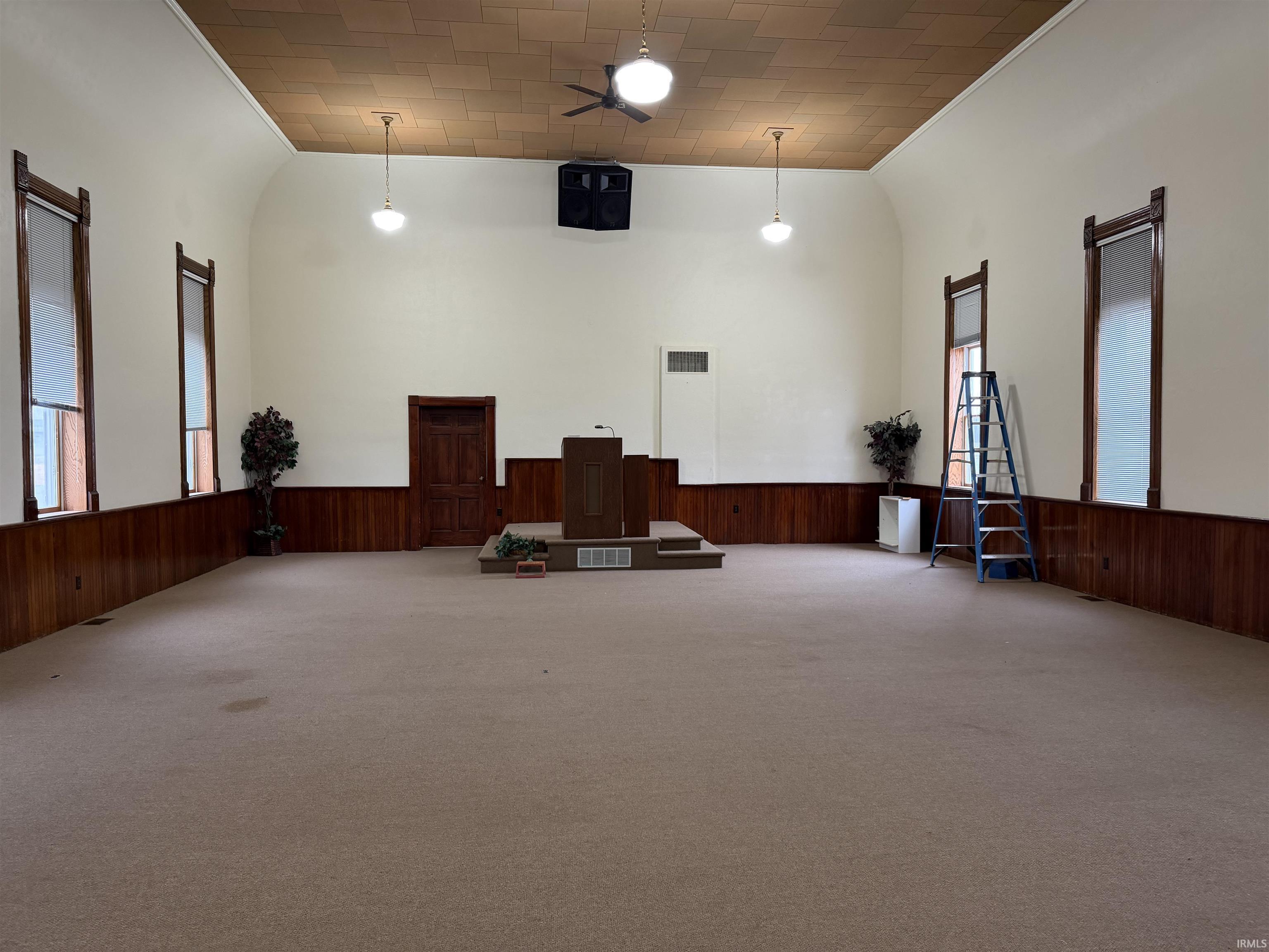 Carpeted sanctuary with wainscoted wall, and ornamental molding, great lighting, large beautiful windows.