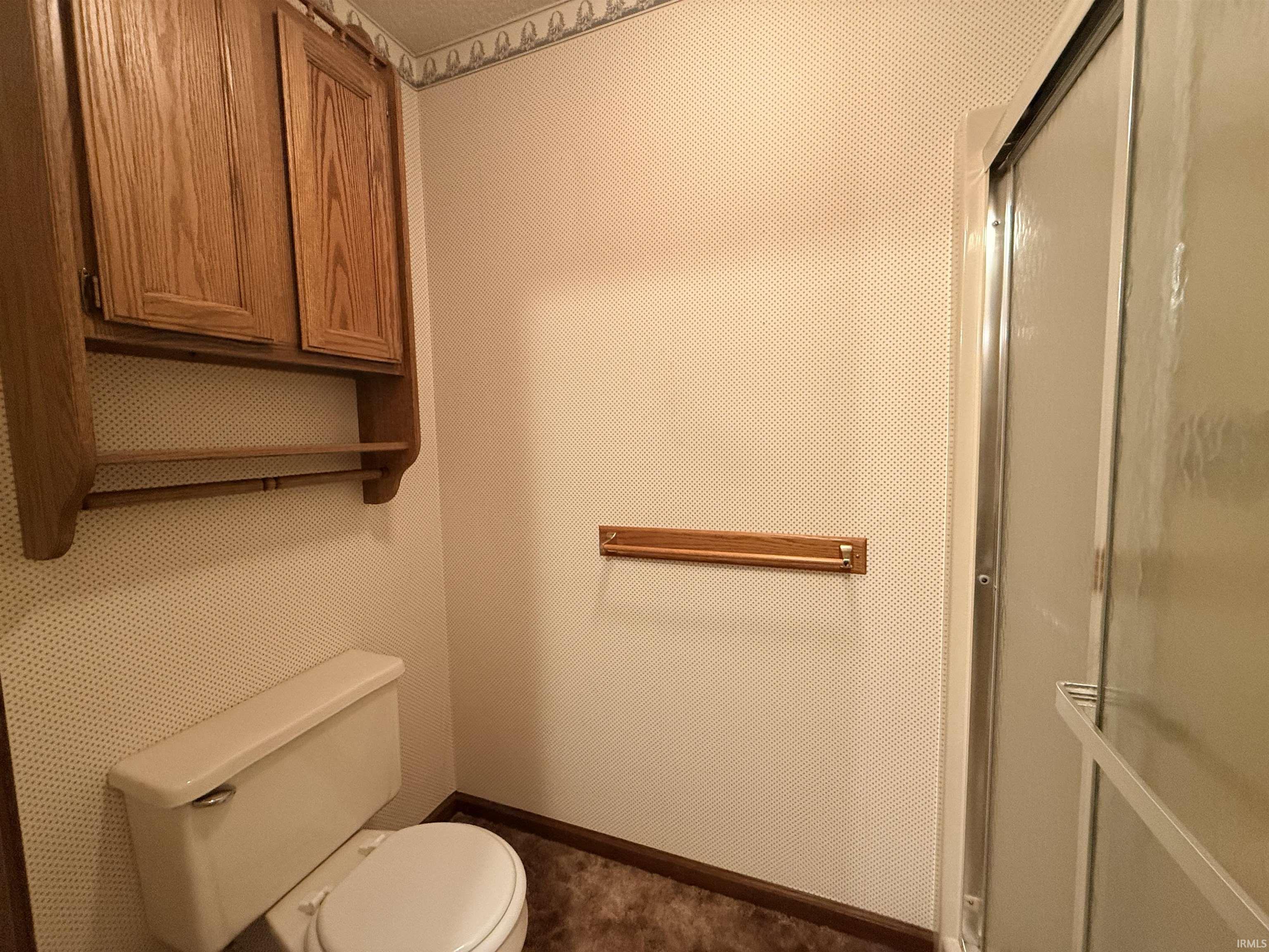 Half bathroom featuring toilet and baseboards